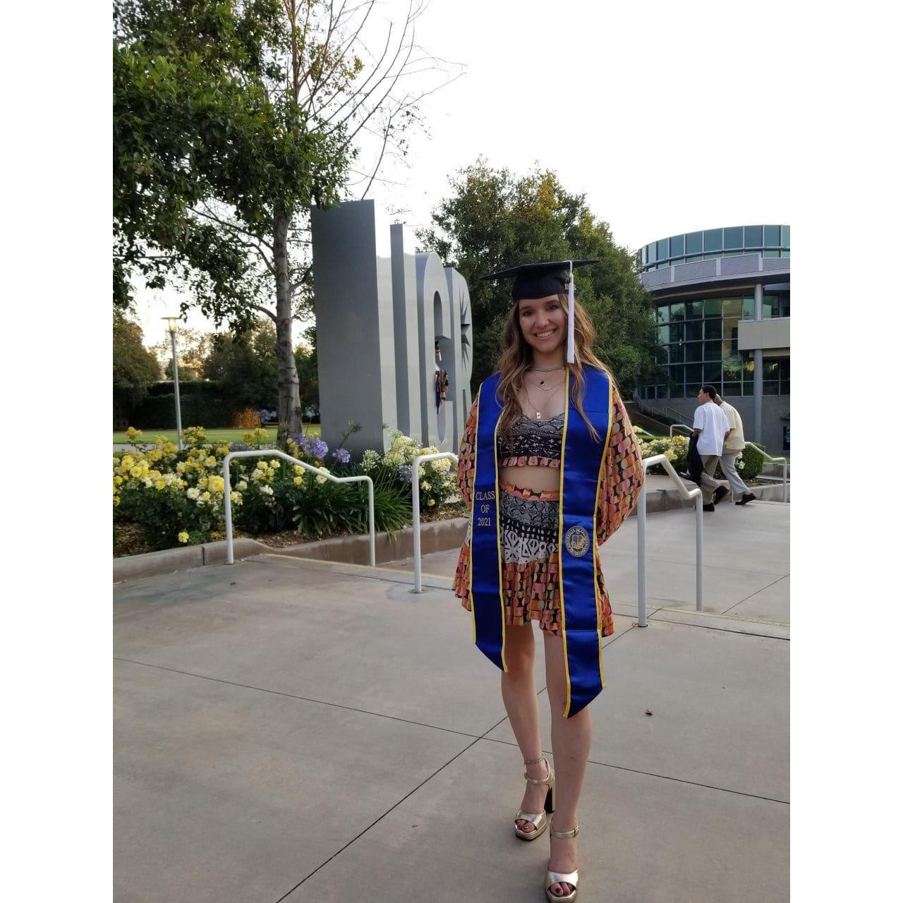 Genesis being photographed by Raul, her father, a day later for her UCR psychology major human-drive-thru graduation ceremony.