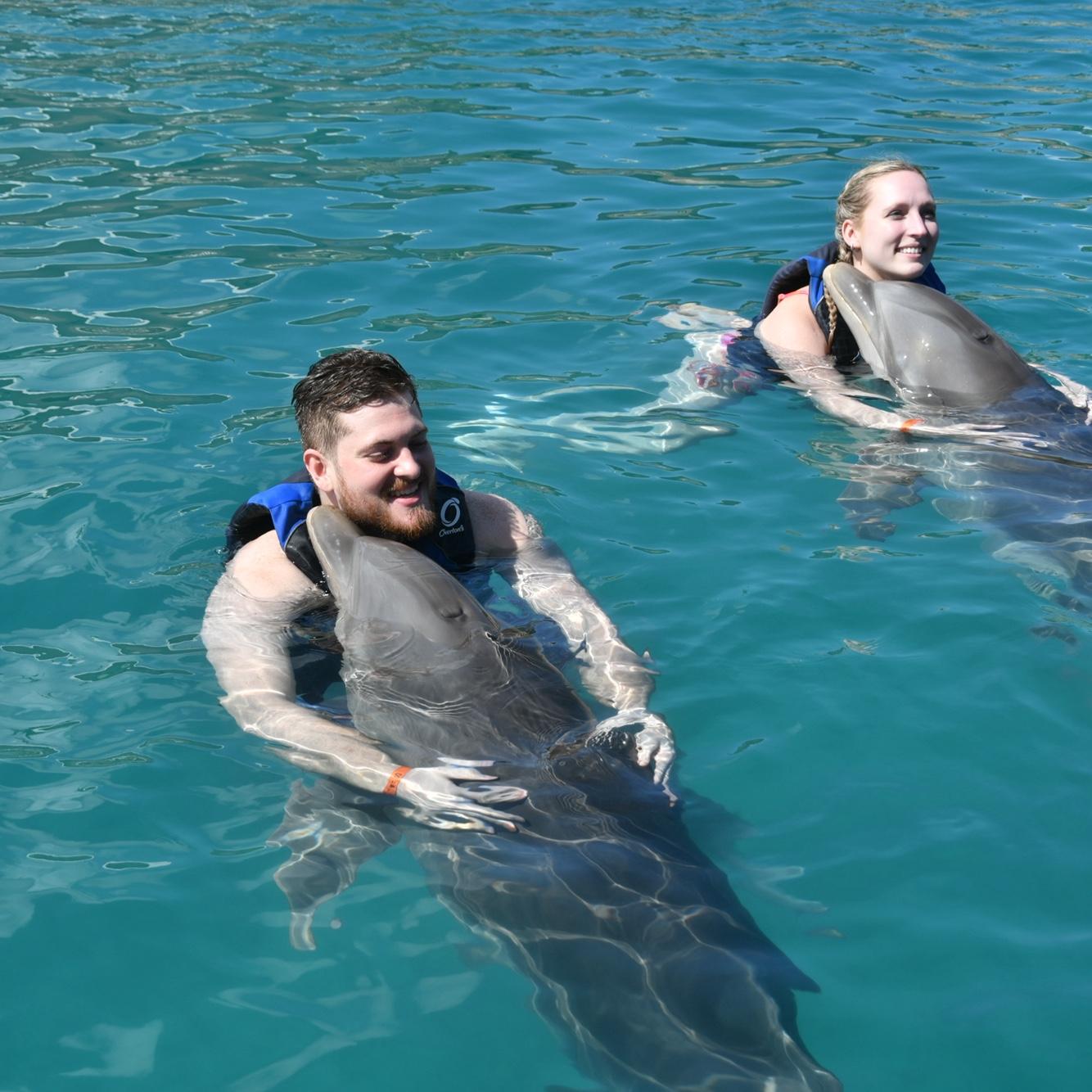 Us hugging dolphins in Dominican Republic.