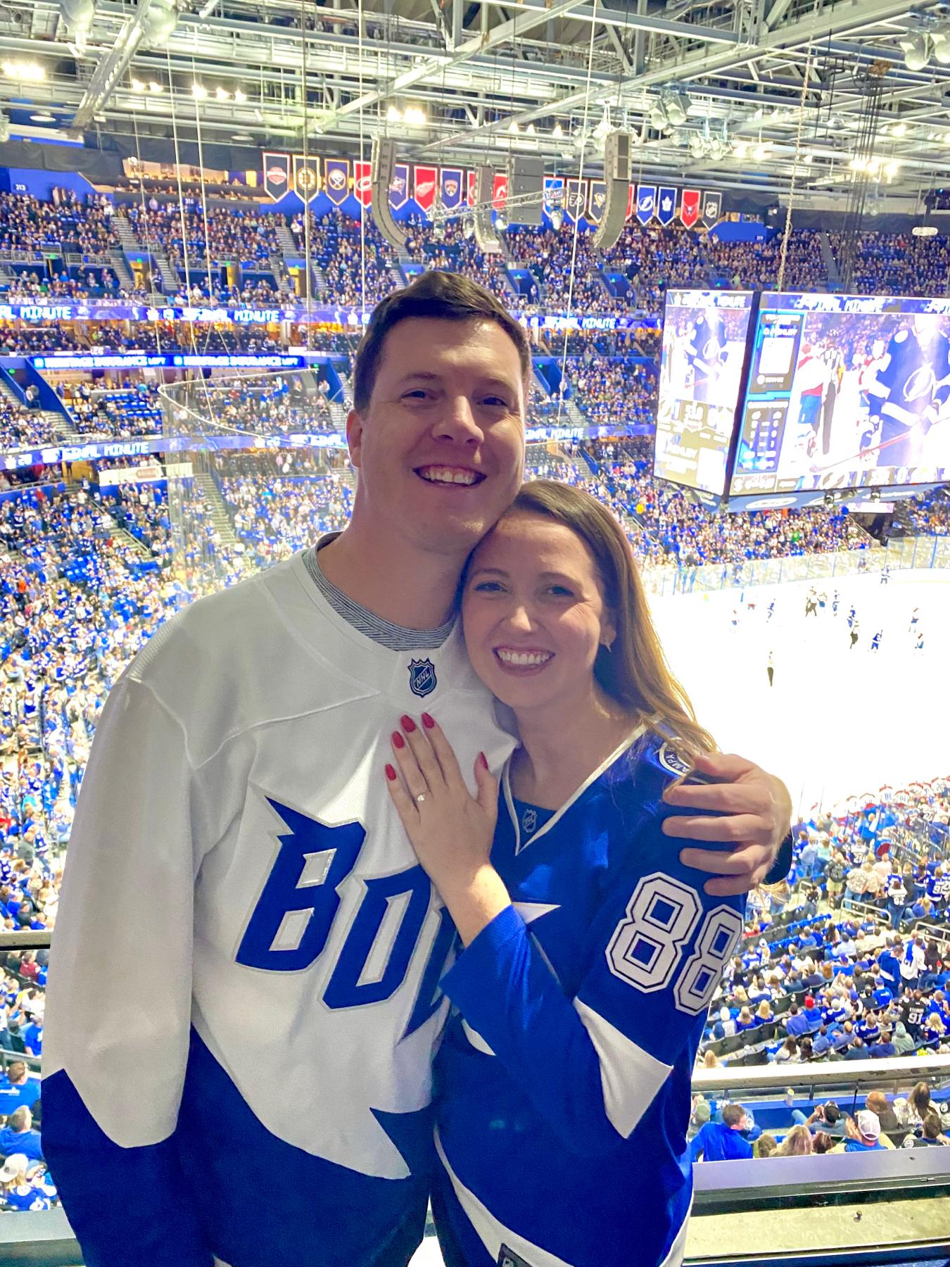 February 9, 2023 - After Kevin’s romantic proposal at their favorite place in Tampa (sunset on their apartment balcony), Kevin brought Sydney to their second favorite place in Tampa: Amalie Arena!