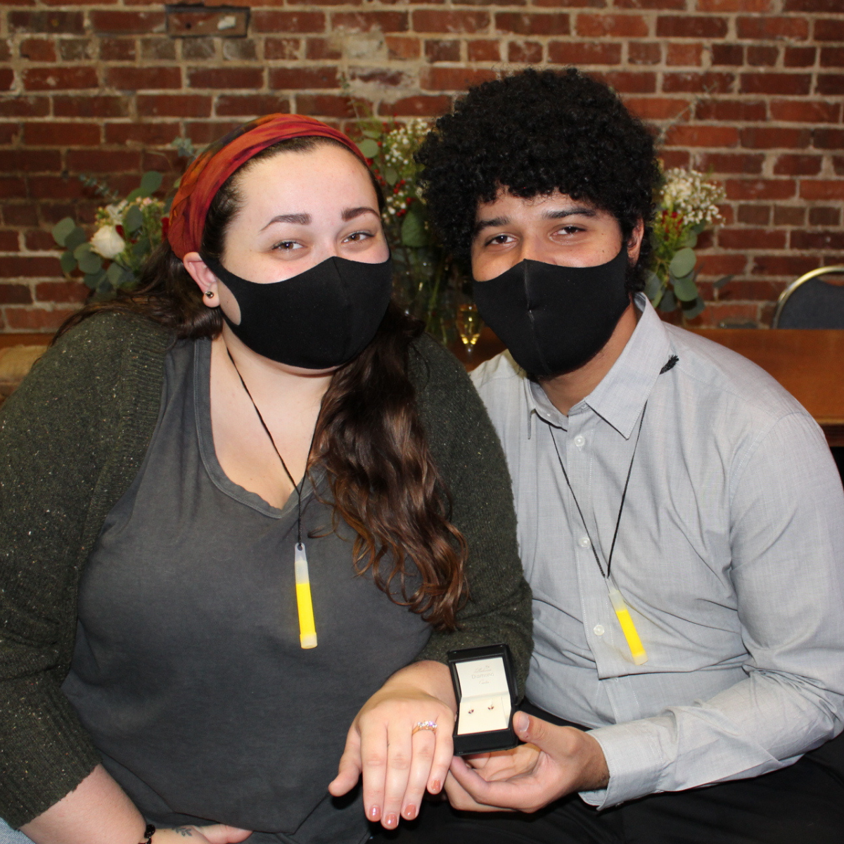 A picture of us from when Jo proposed/threw me a surprise Engagement Party! He is holding a pair of earrings that he had made to match my engagement ring.