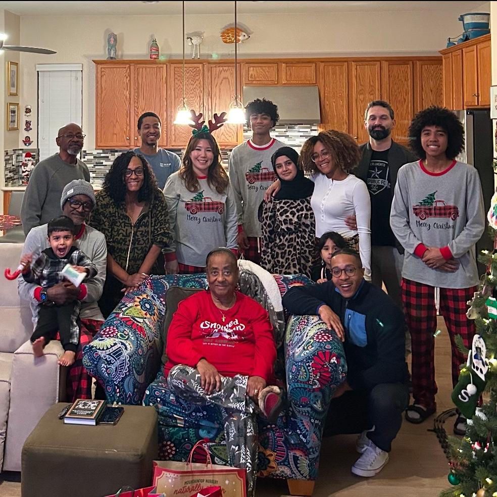 Our family pausing Christmas shenanigans to take a photo.