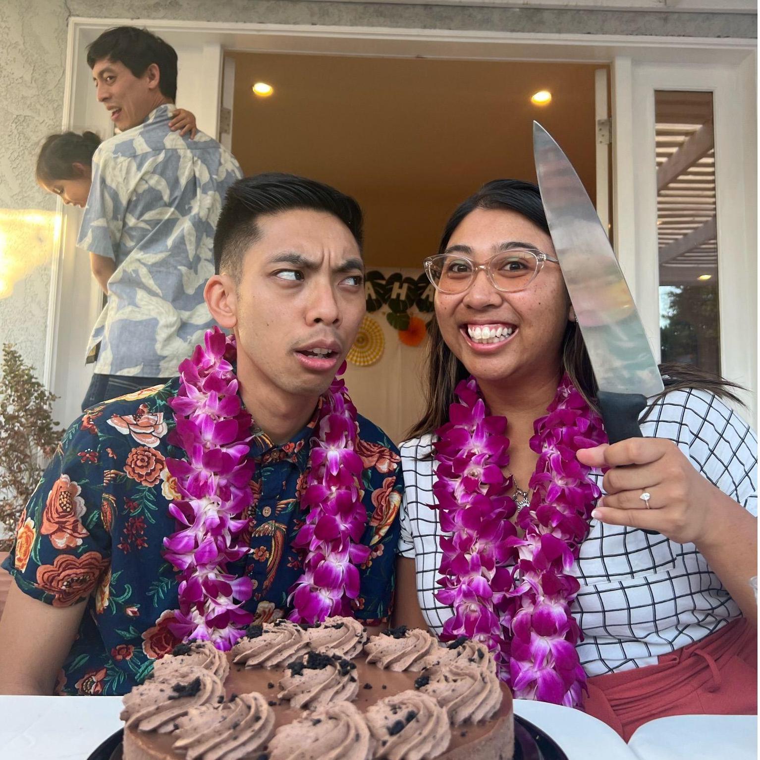 We were cutting the cake together for our engagement party. Someone handed me a knife, and immediately asked to take a photo. So we posed together in a way that felt most natural!