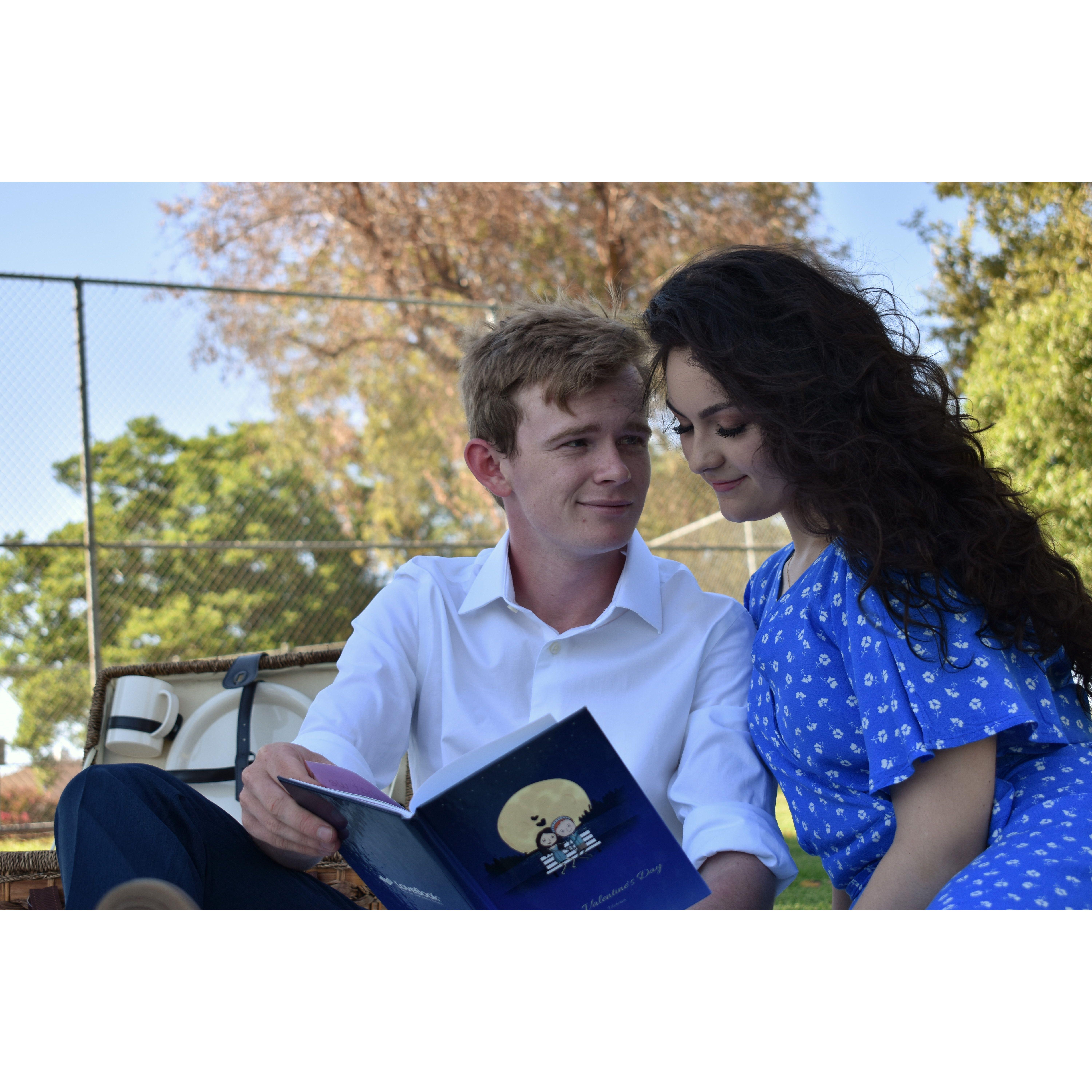 The book Nolan is holding was created by Victoria about their love story as a gift for their first Valentine's Day together
