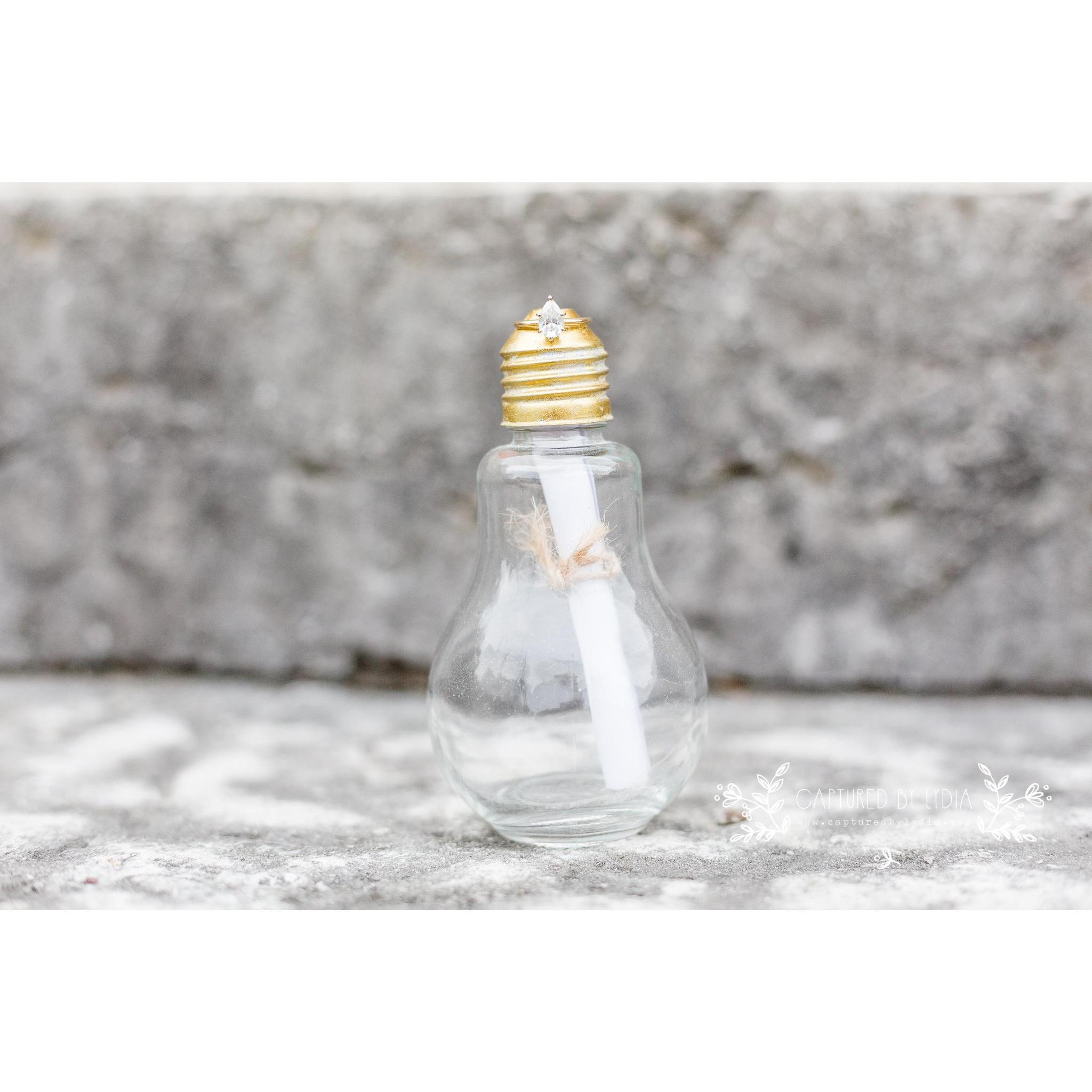 When Austin proposed, he used this lightbulb jar that she had gifted him two years prior. She opened the scroll to see the words "Marry Me," as he got on one knee and held up her ring.