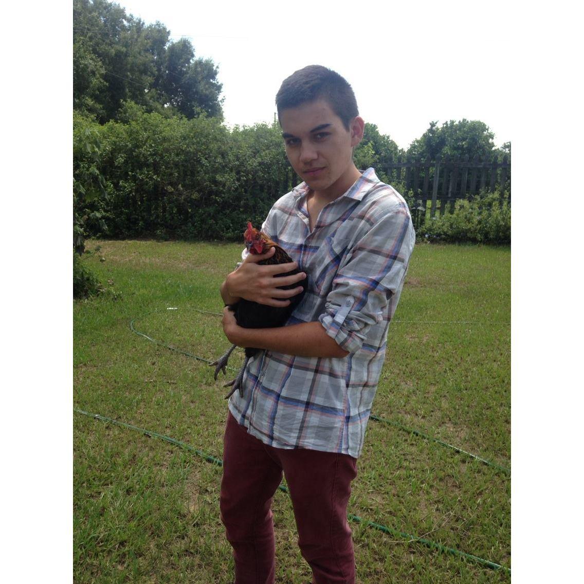 The first time Dion was at my house! Holding our chickens lol