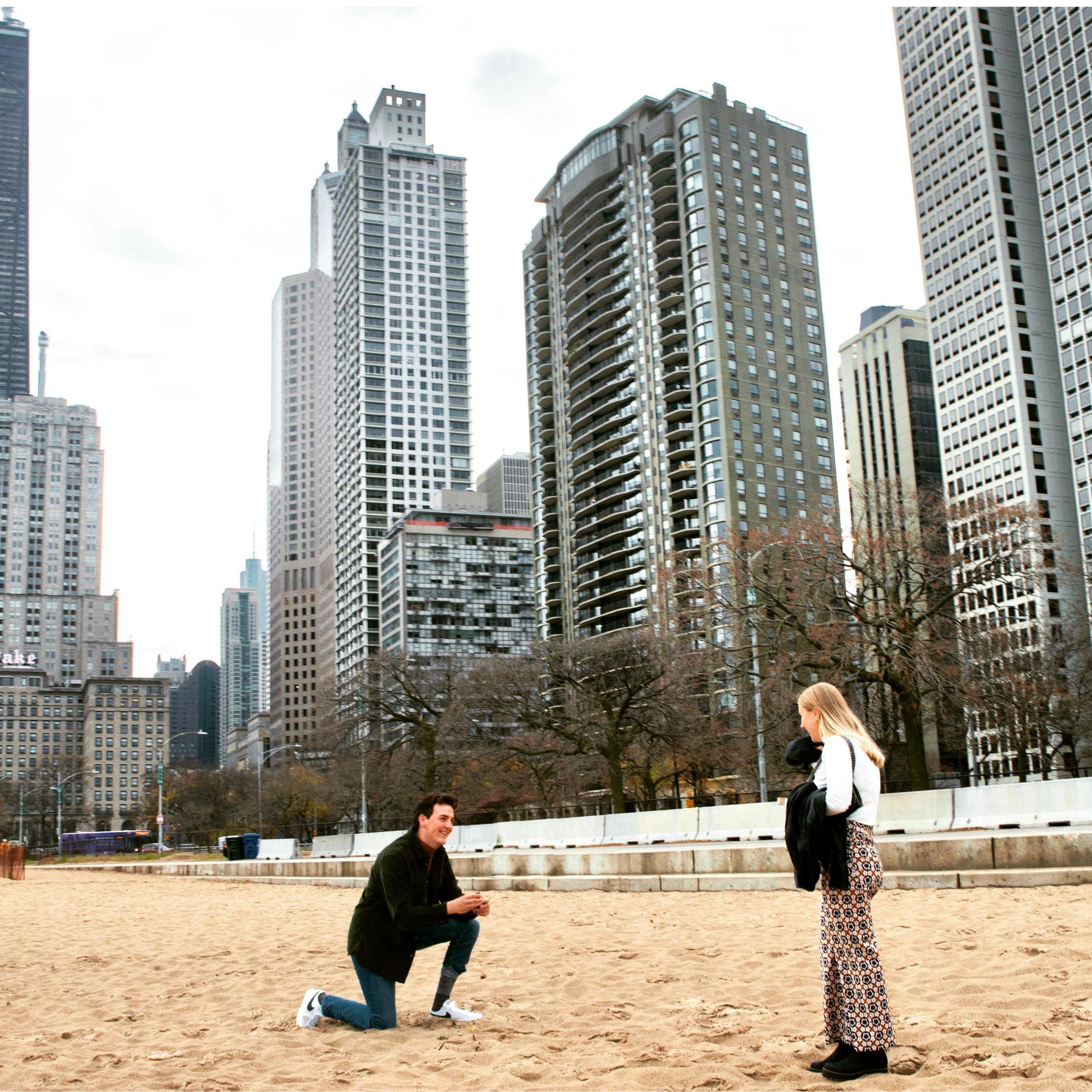 Charles proposing at Oak Street beach in Chicago