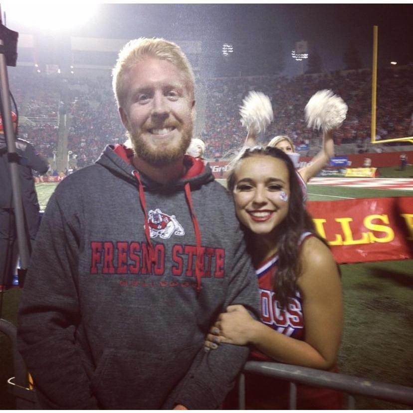 Derrick cheering on his favorite cheerleader.