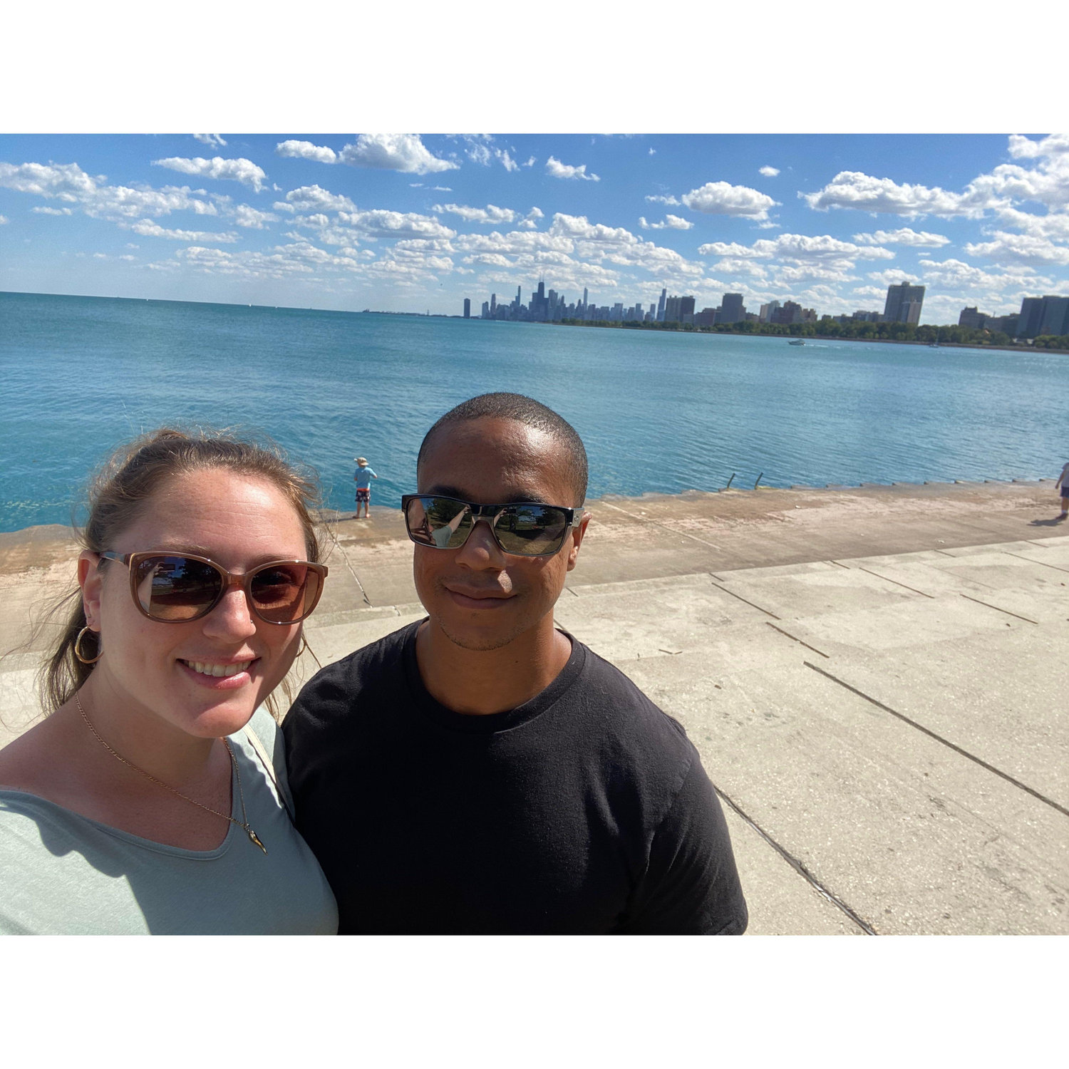 Walking along Montrose harbor with a view of the Chicago skyline.