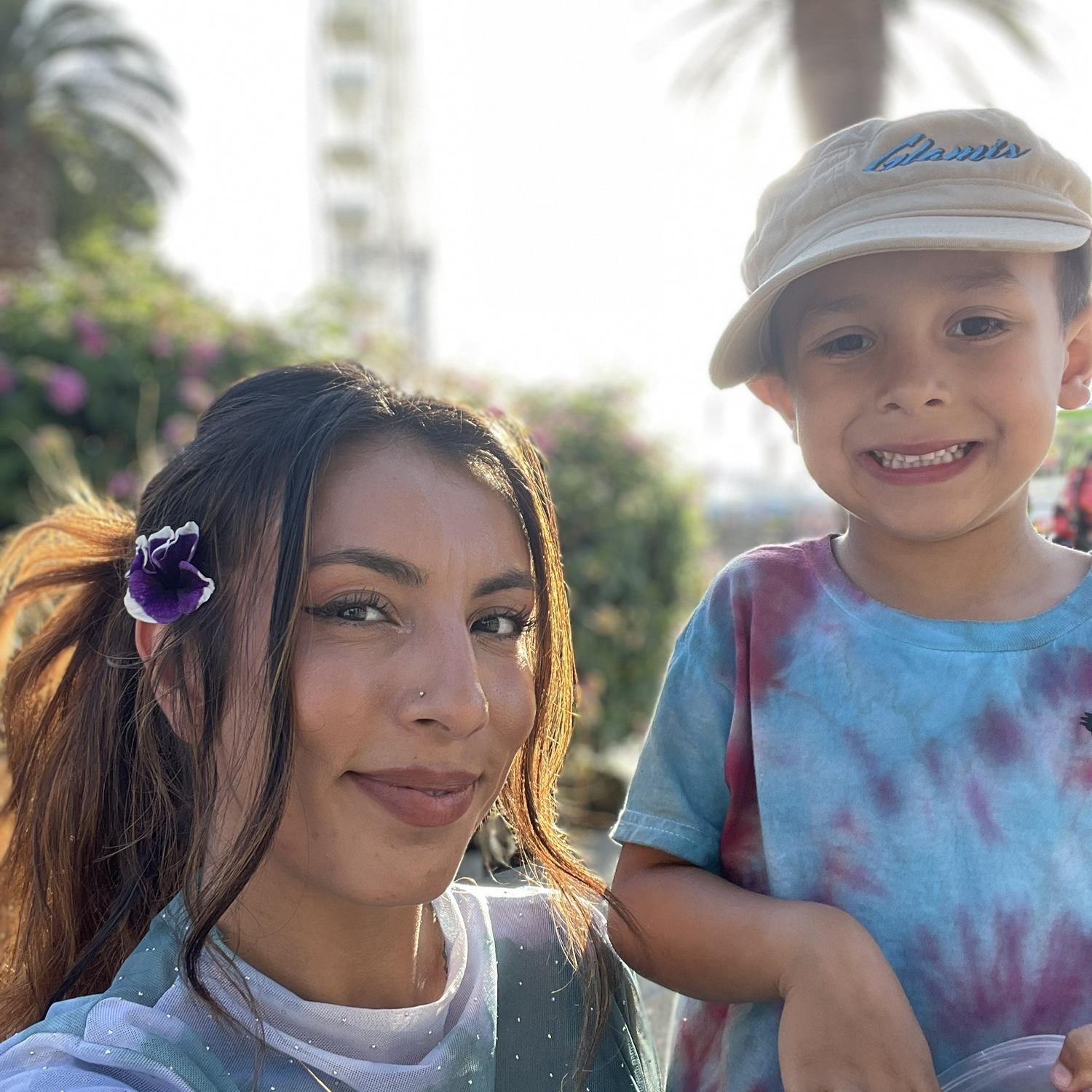 This sweet boy will always find a flower to pick for his mom .