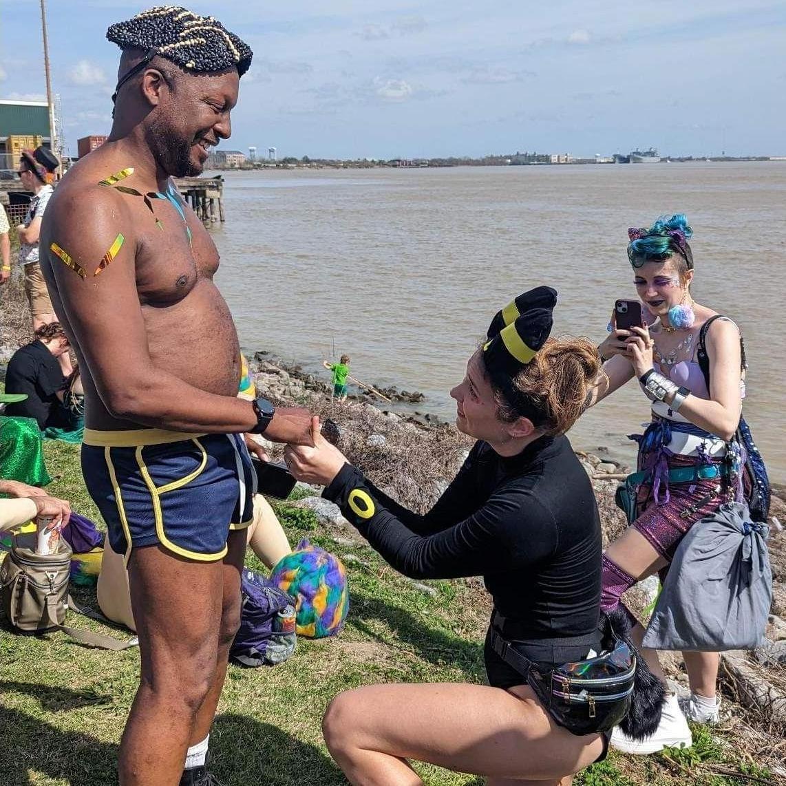 Mary proposed to Paul on Mardi Gras Day in 2023, dressed as Paul's favorite Pokemon (Umbreon). While he noticed the costume earlier that day, he was still surprised by the proposal at the river.