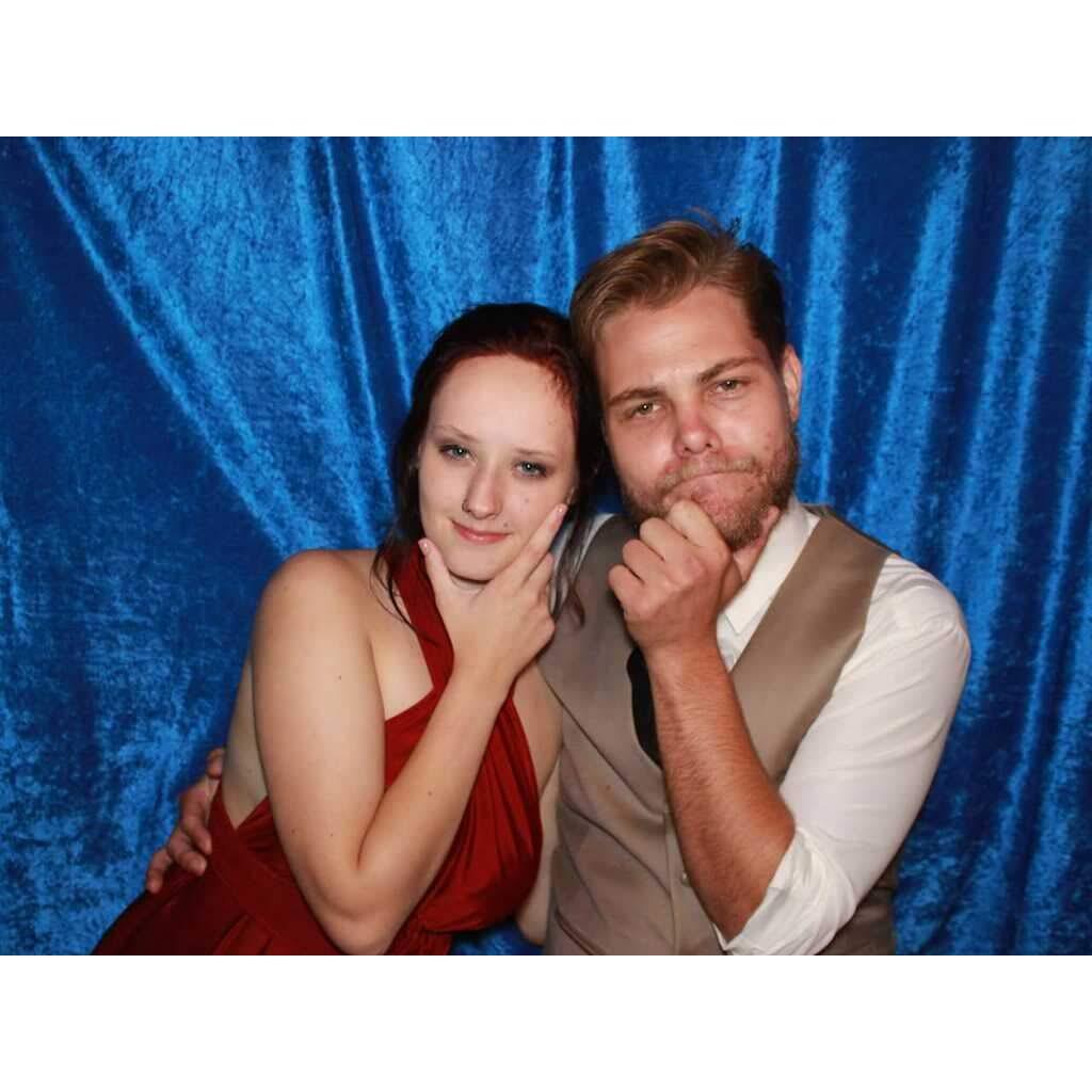 This was the first photo we ever took together! We were both part of the wedding party and snuck away to enjoy the photo booth they had on site. We were trying to take a "serious" picture!