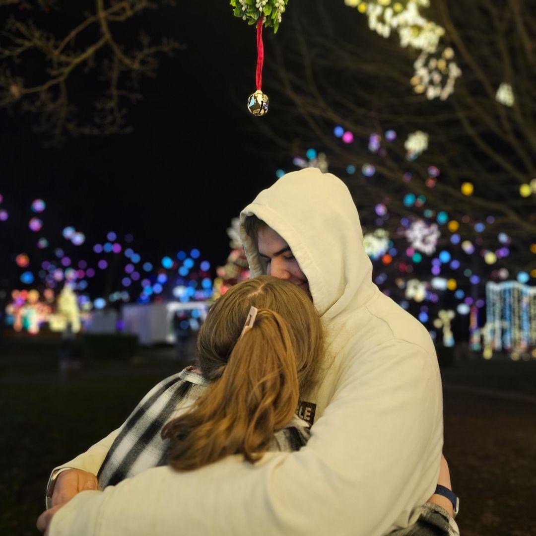 Under the mistletoe.