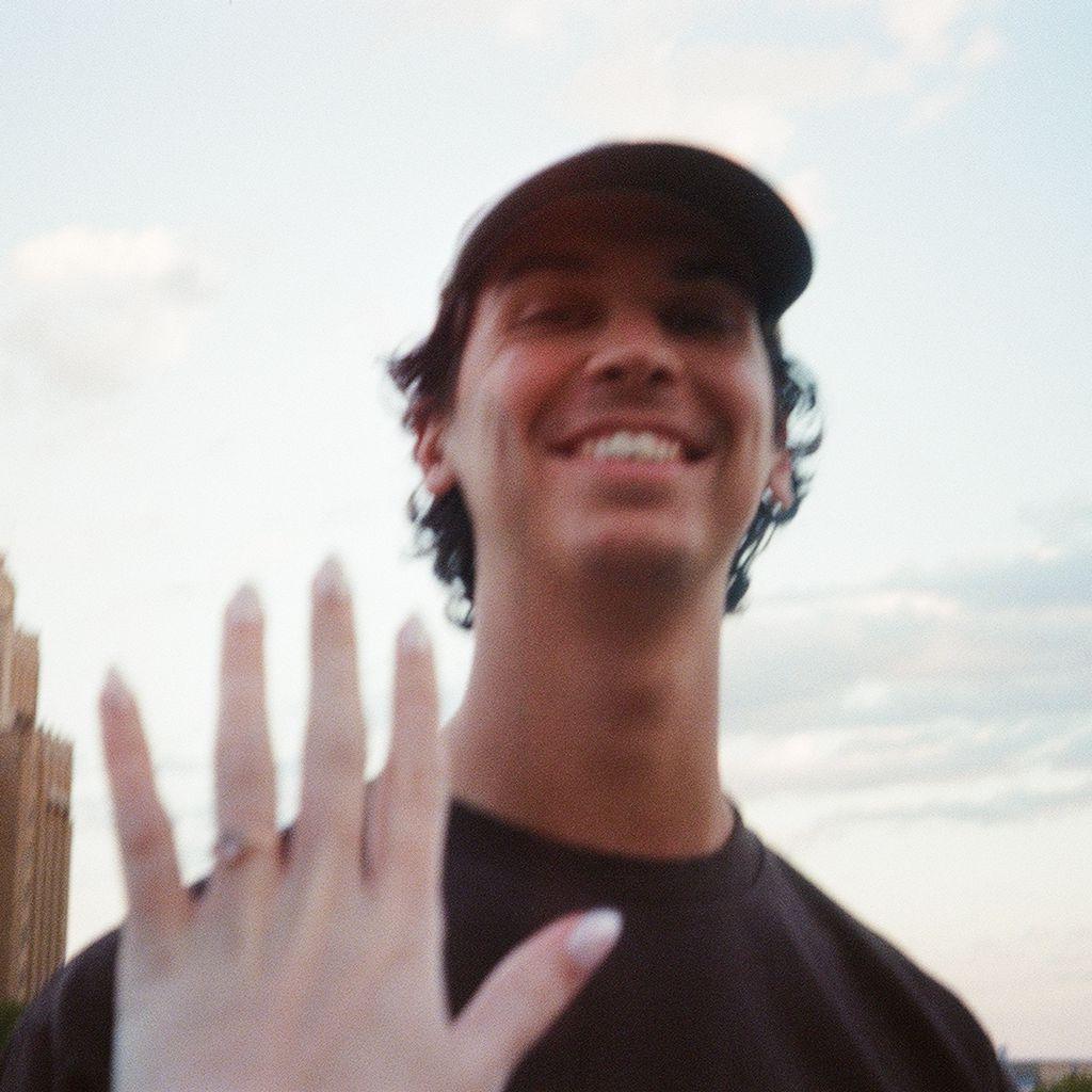 Marcus and Courtney showing off her ring. Marcus had bought her ring back in August 2025 during a trip to Maine. She loves non-traditional ring styles and this pink morganite was the perfect find!