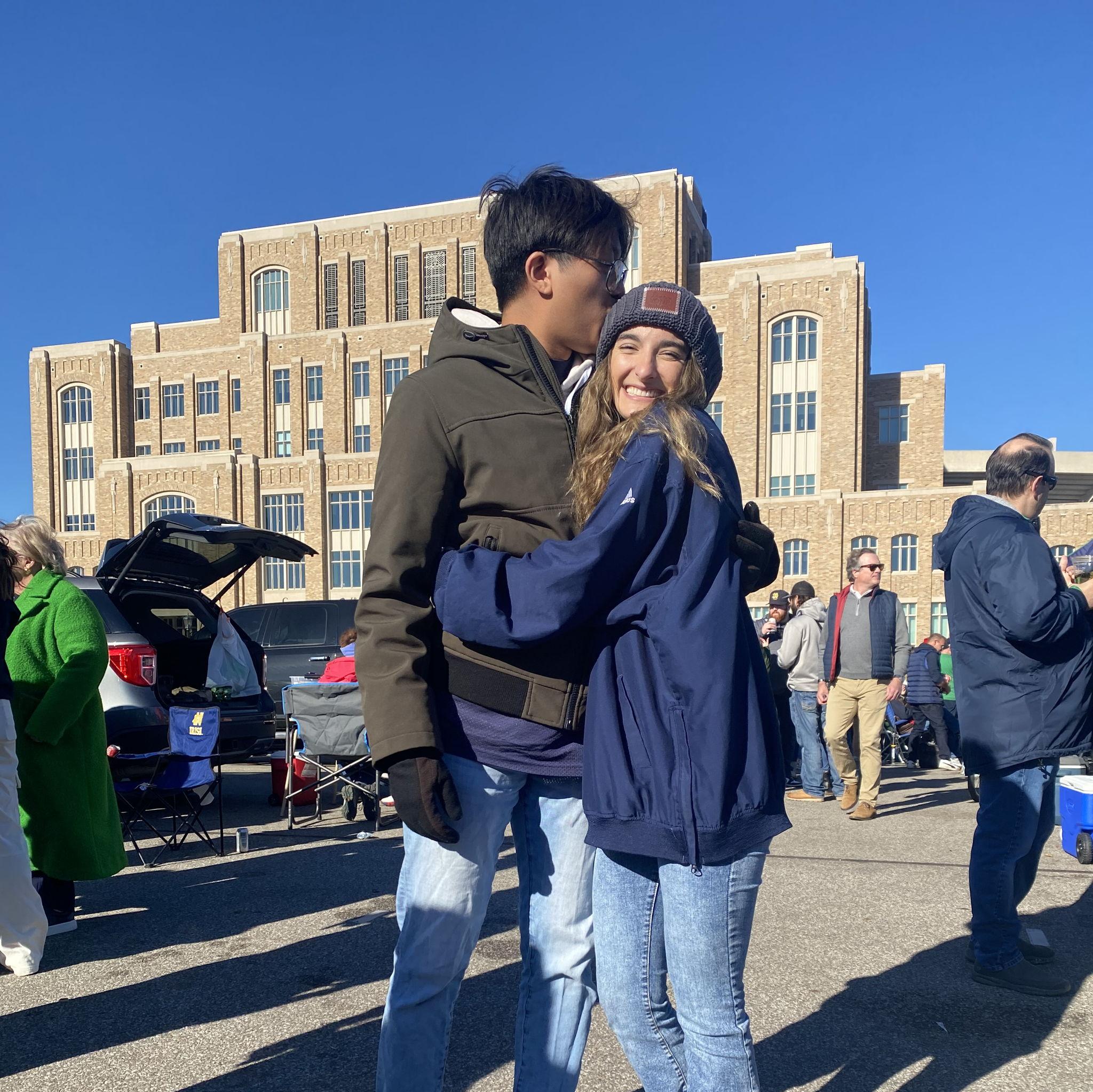 Smiling at our inaugural Carles-Royeca tailgate after staying up all night frying lumpia and grilling Filipino barbecue!