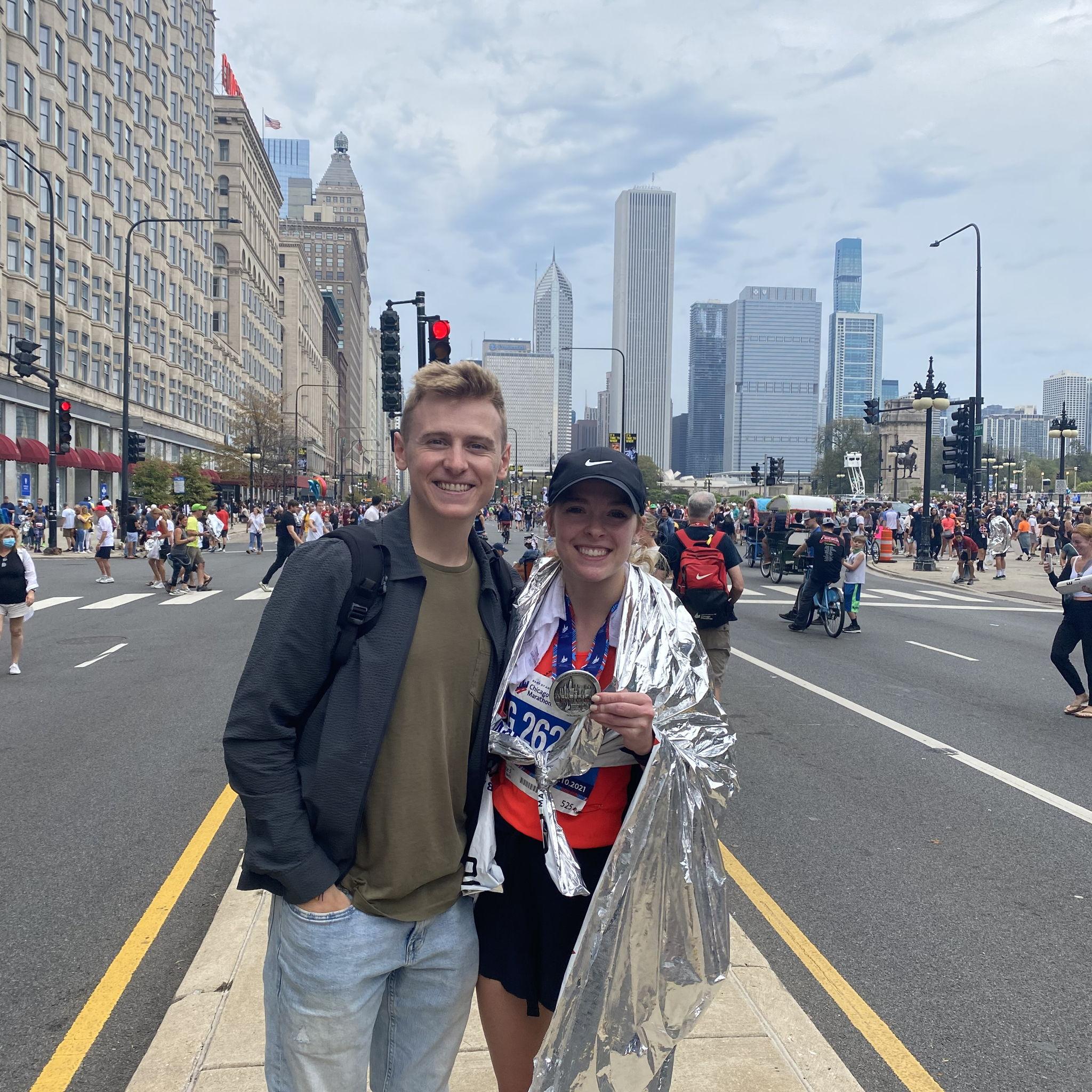 Emily running the Chicago Marathon in 2021. Danny cheered her on along the 26.1 mile route!