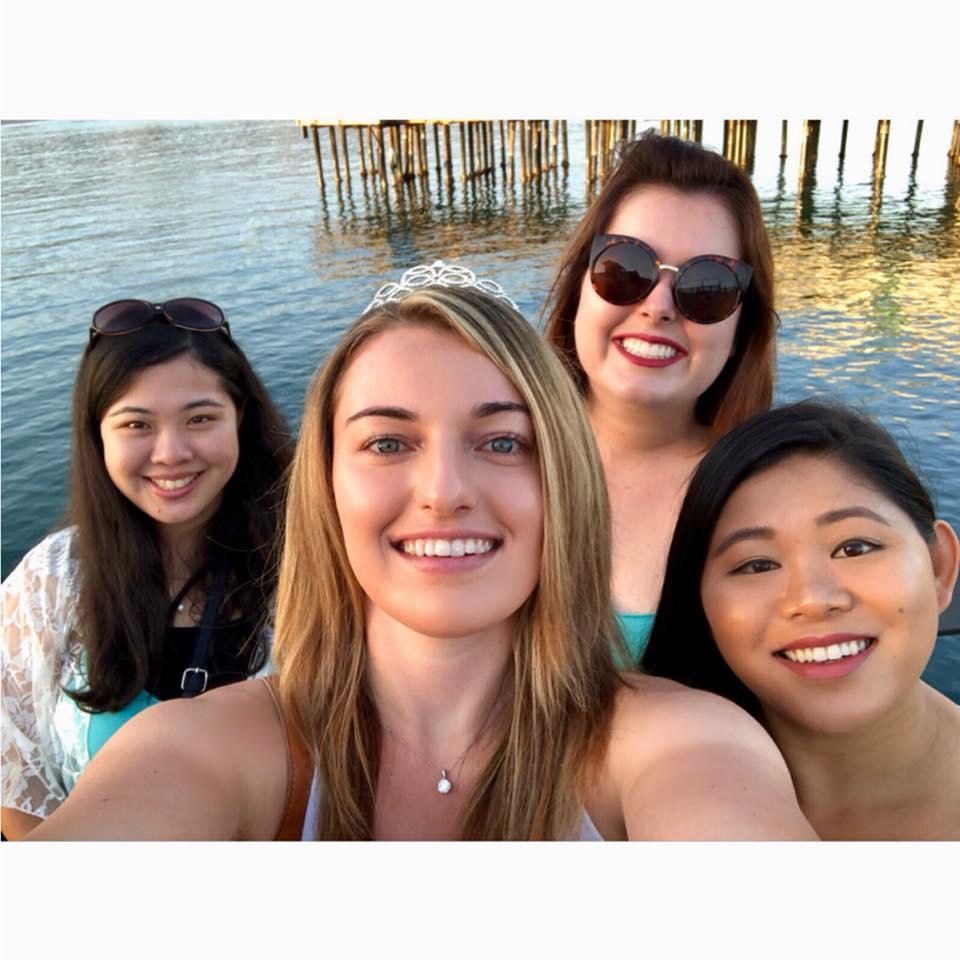 Nicole, Jessica, Katherine, and Kalia celebrating Jessica's bachelorette weekend at a winery on the pier