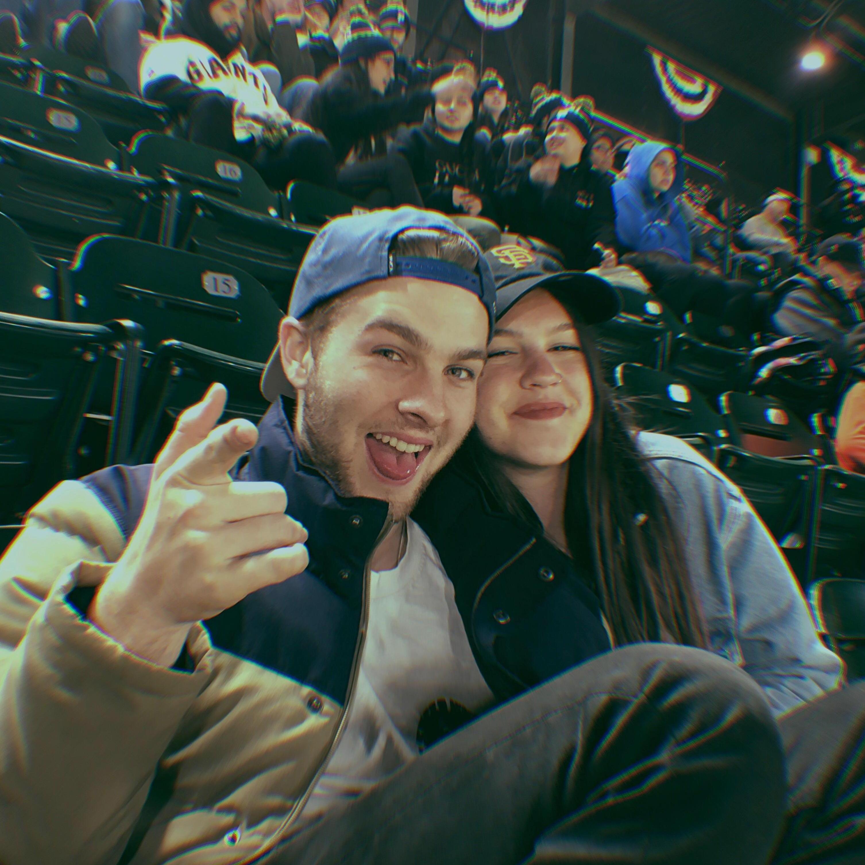 At a Giants game, probably eating some garlic fries.
