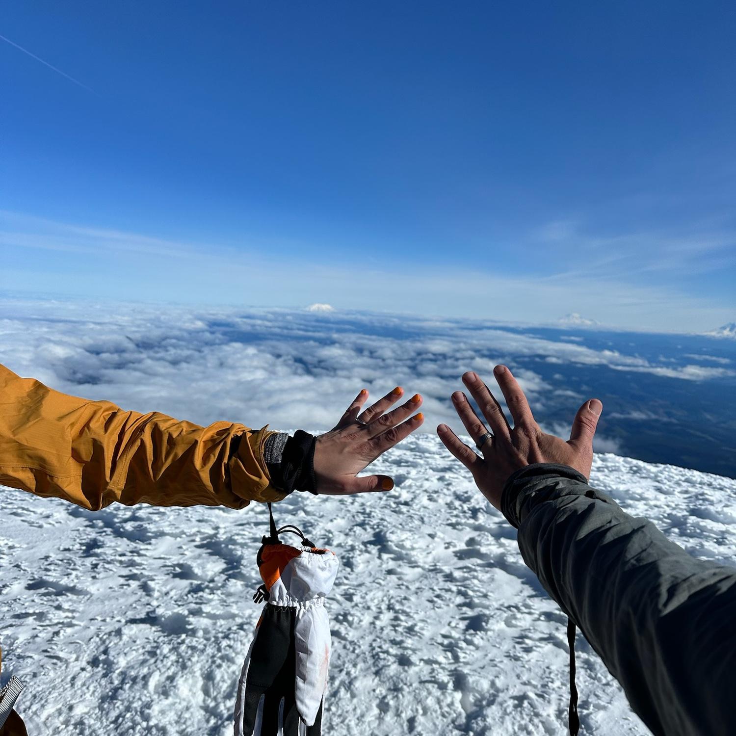 Ring photo. Mark's ring is made out of tantalum with the Mt. Hood summit coordinates engraved on the inside. Katie's ring is white gold with "Till Death" engraved on the outside