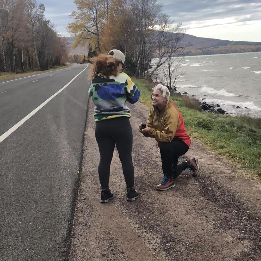 Erica proposes to Kelly roadside in the entrance to the Porcupine Mountains