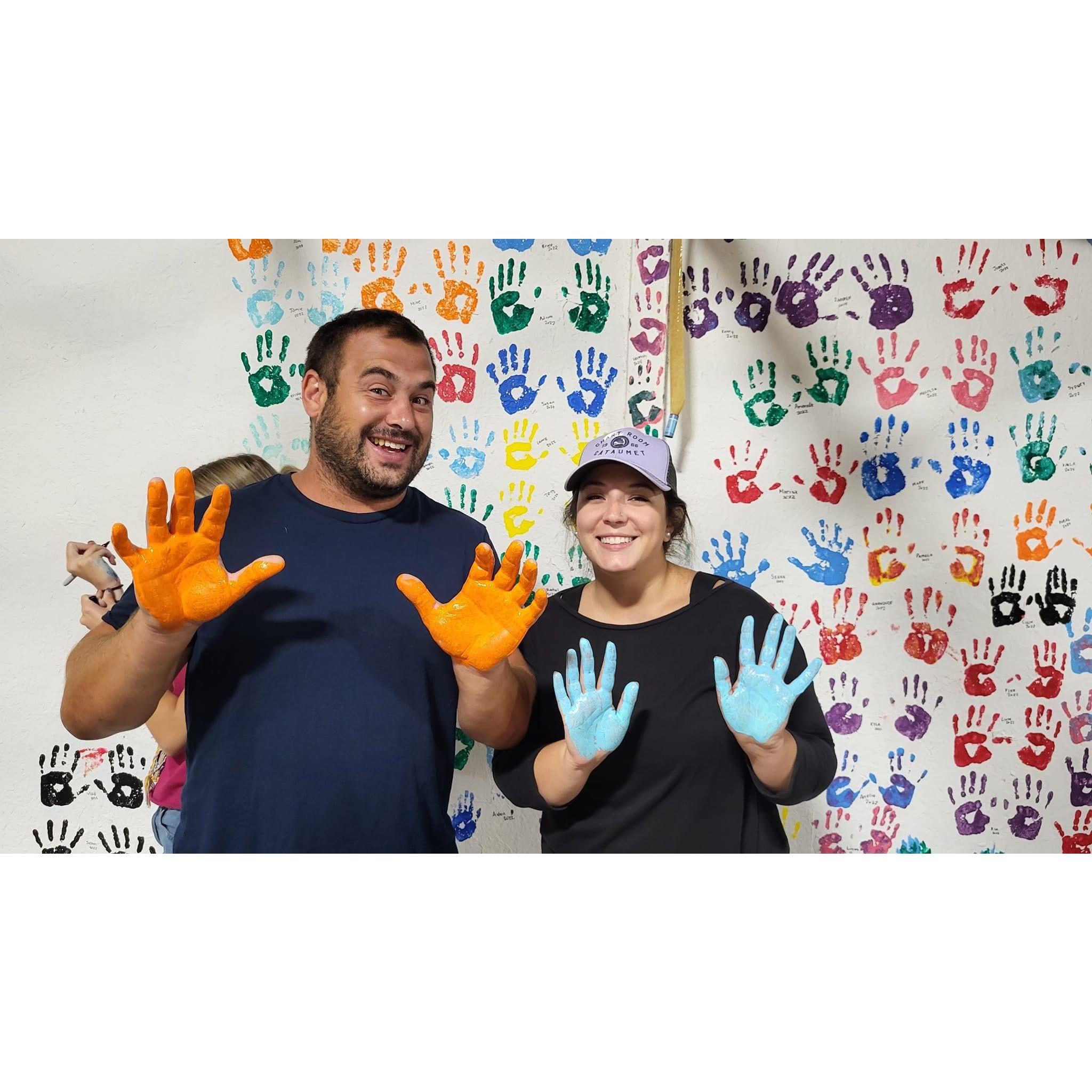Putting our handprints on the wall of the rec room