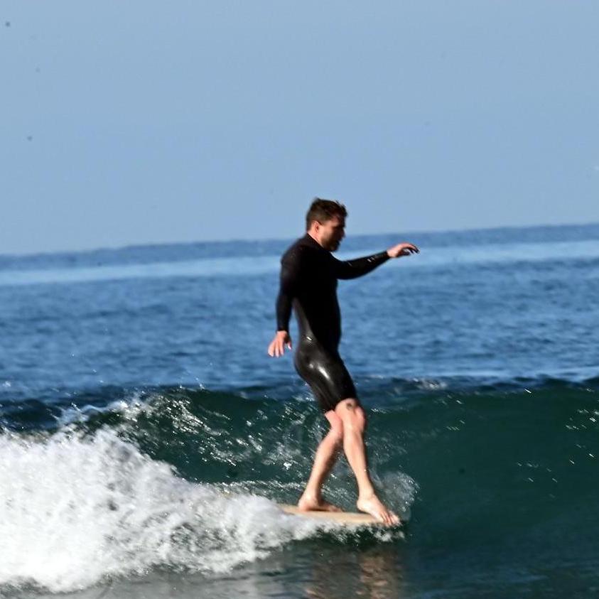 Toes on the nose! Buddy surfing at his favorite surf spot, Pipes!