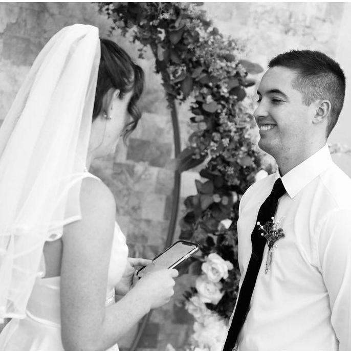 Gabby reading her vows at their elopement in Vegas
