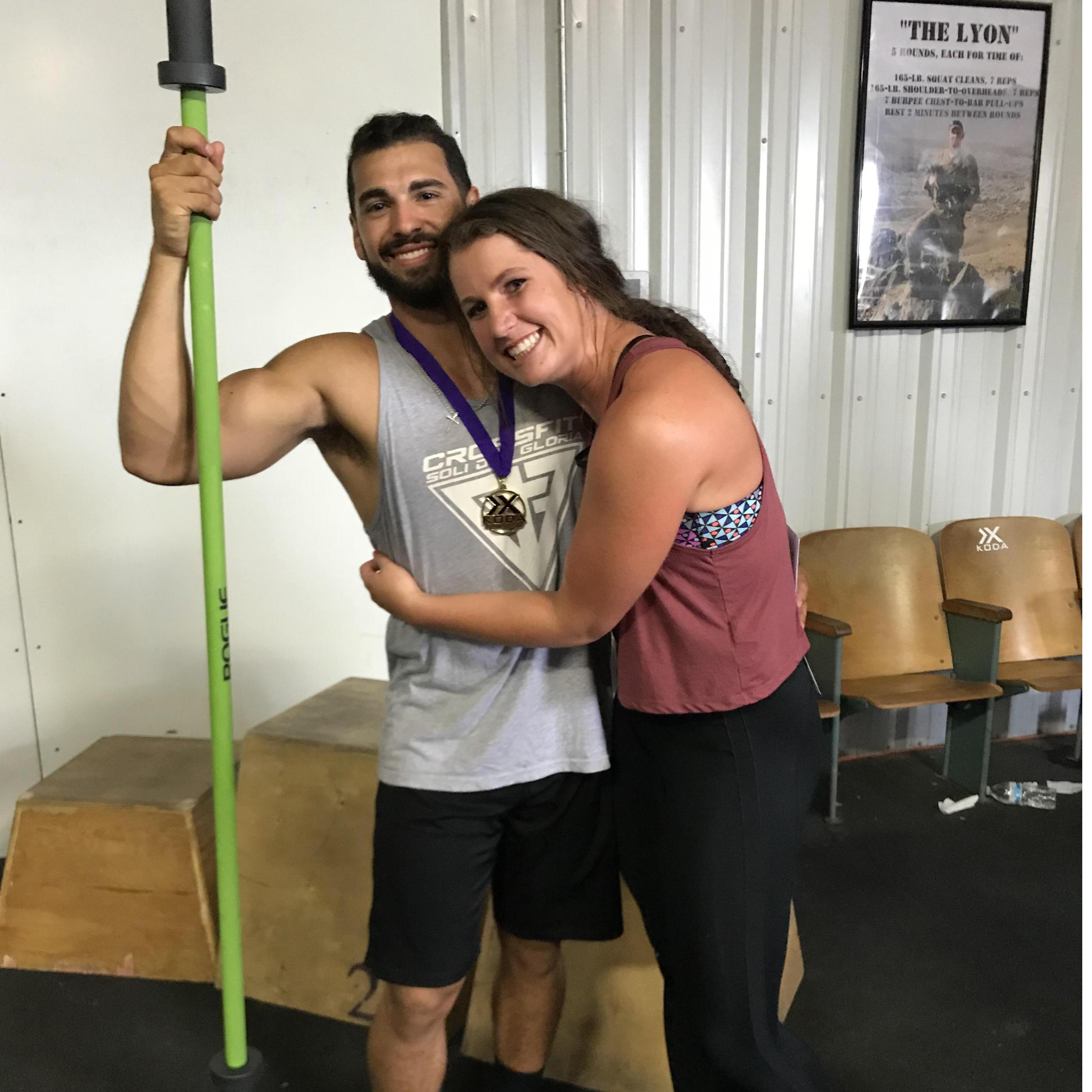 Matt's first crossfit comp ever... note the barbell that he won for getting first. More importantly note the first stages of my teaching him the importance of physical touch(;