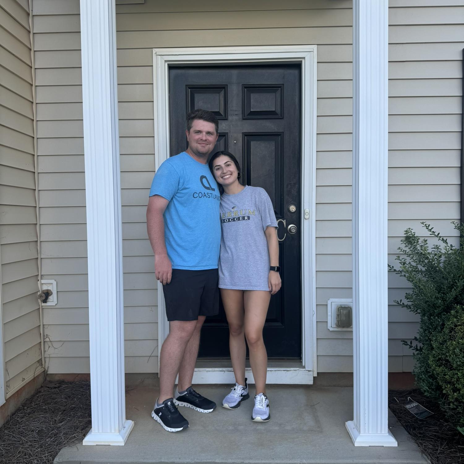 The couples first picture in front of their first home