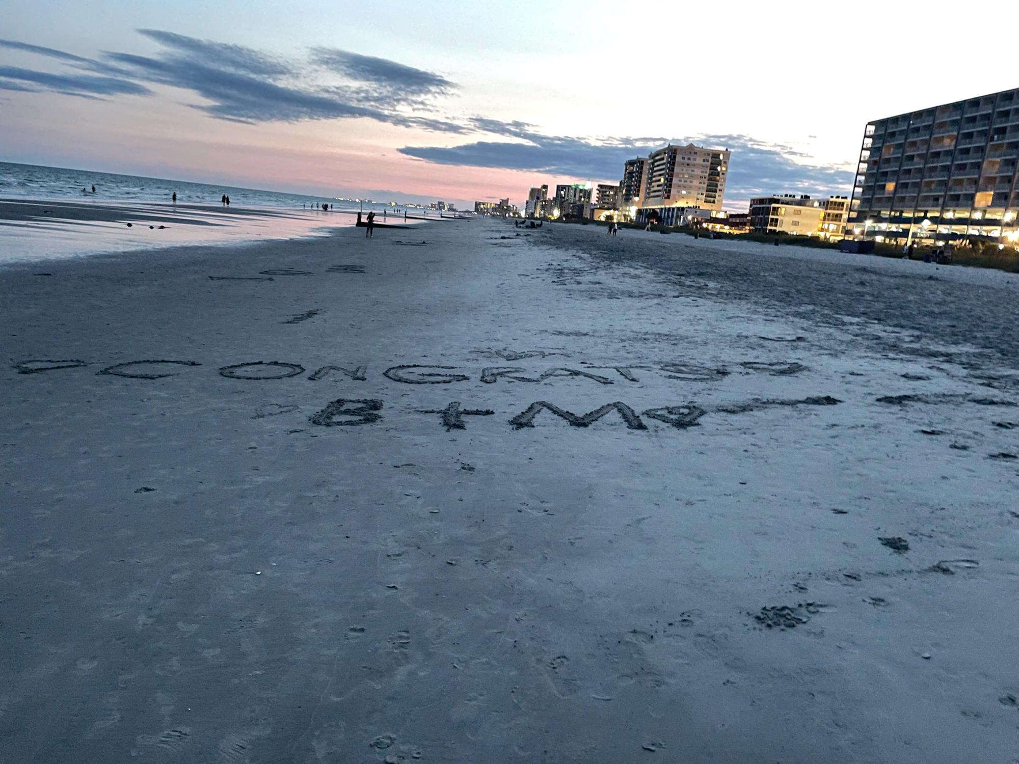 The message Ben’s family had written in the sand after the proposal