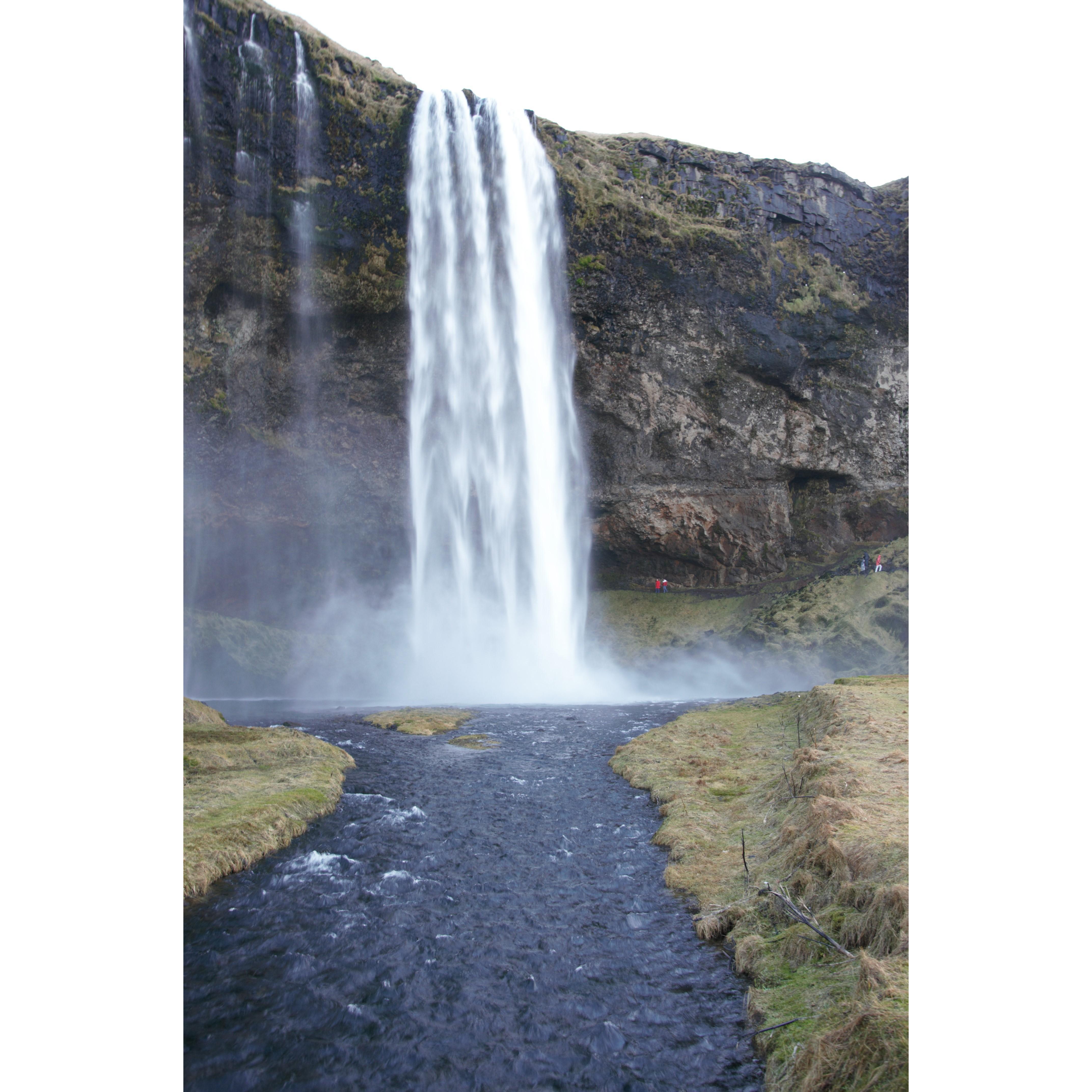 Those two red/white spots back there are us! We ventured behind this waterfall in Iceland even though it was January. Our coats kept us protected, but everywhere else was soaked.