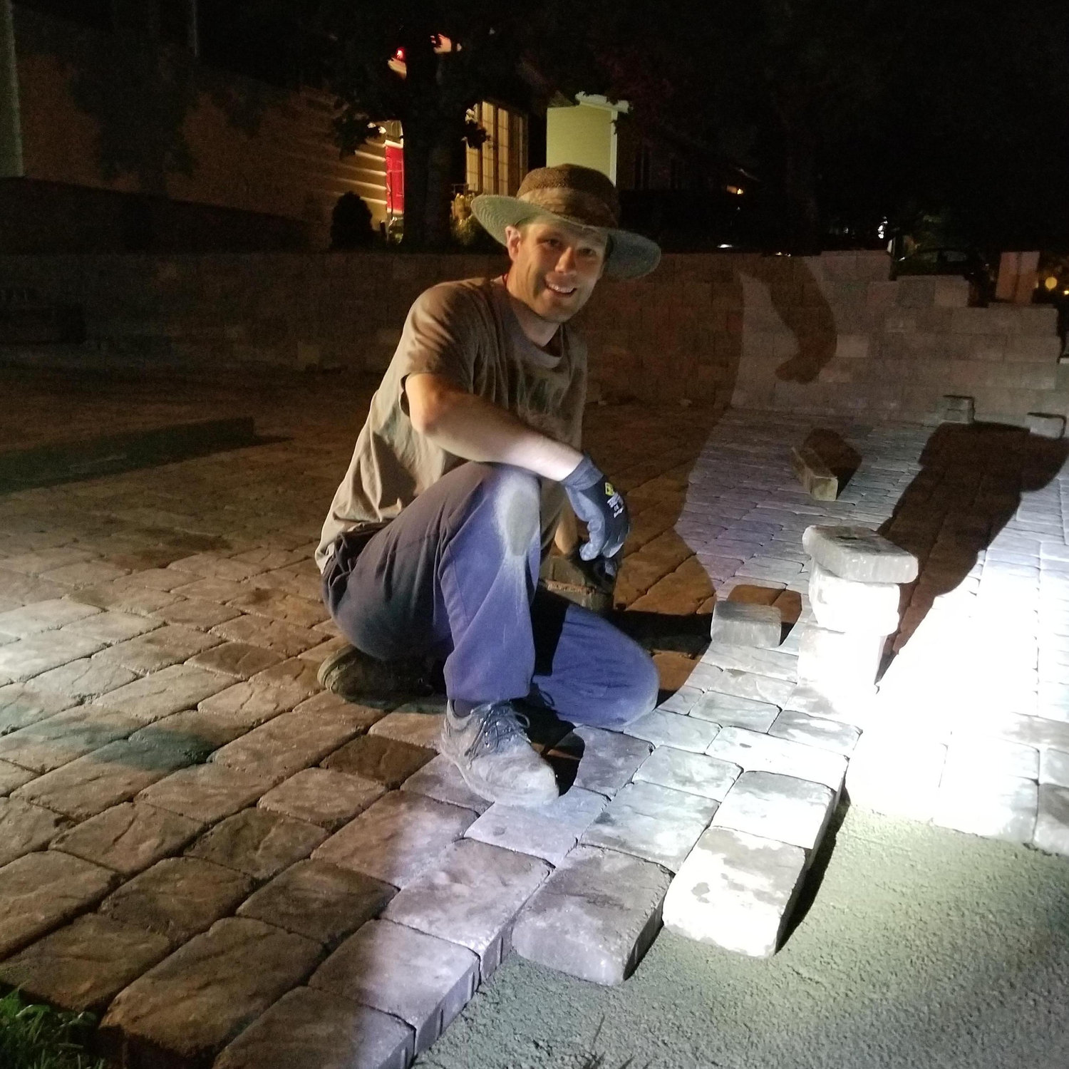 Gower laying paver stones in the dark