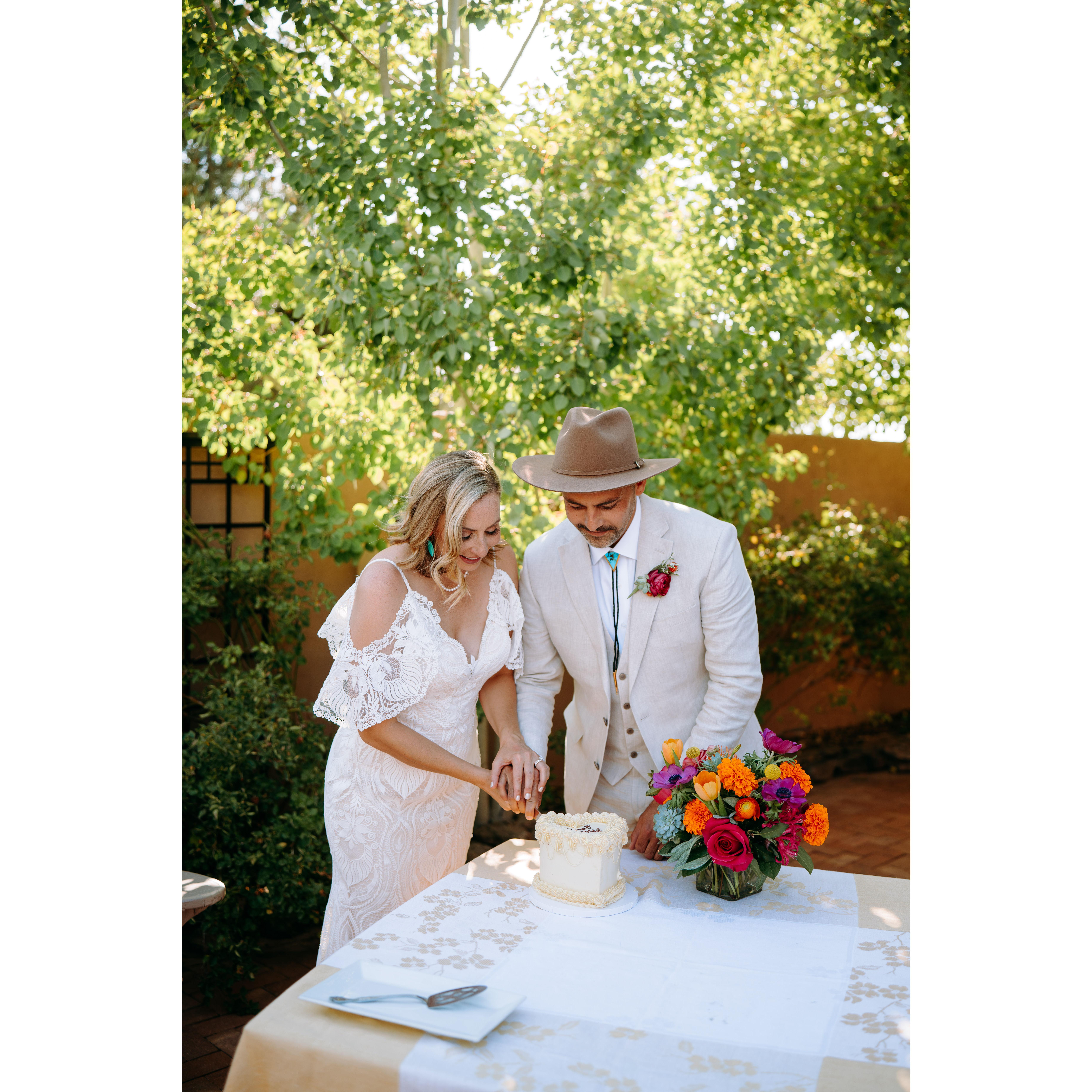 Jenn and Shae have fun cutting the wedding cake