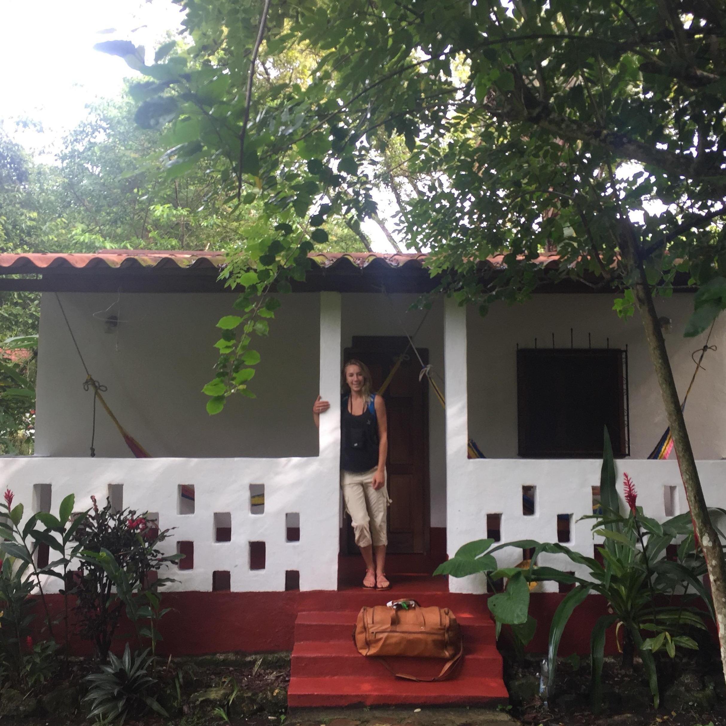 Rachel standing in the entry of our bungalow in a jungle in Guatemala.