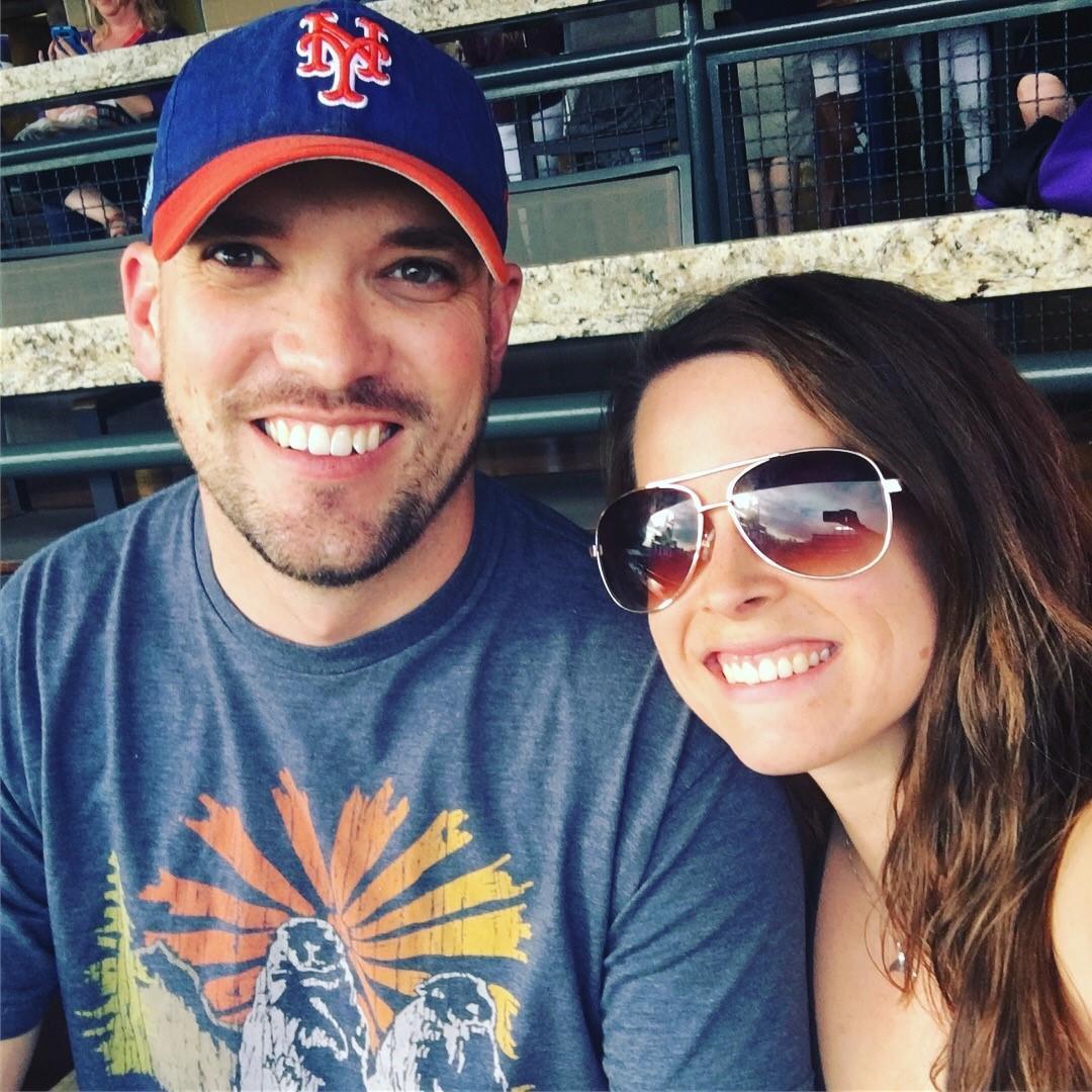 At a Rockies Game together and of course Ty is wearing a Mets hat. Katie is pretending to be a Mets fan at a Rockies game. The things we do for love.