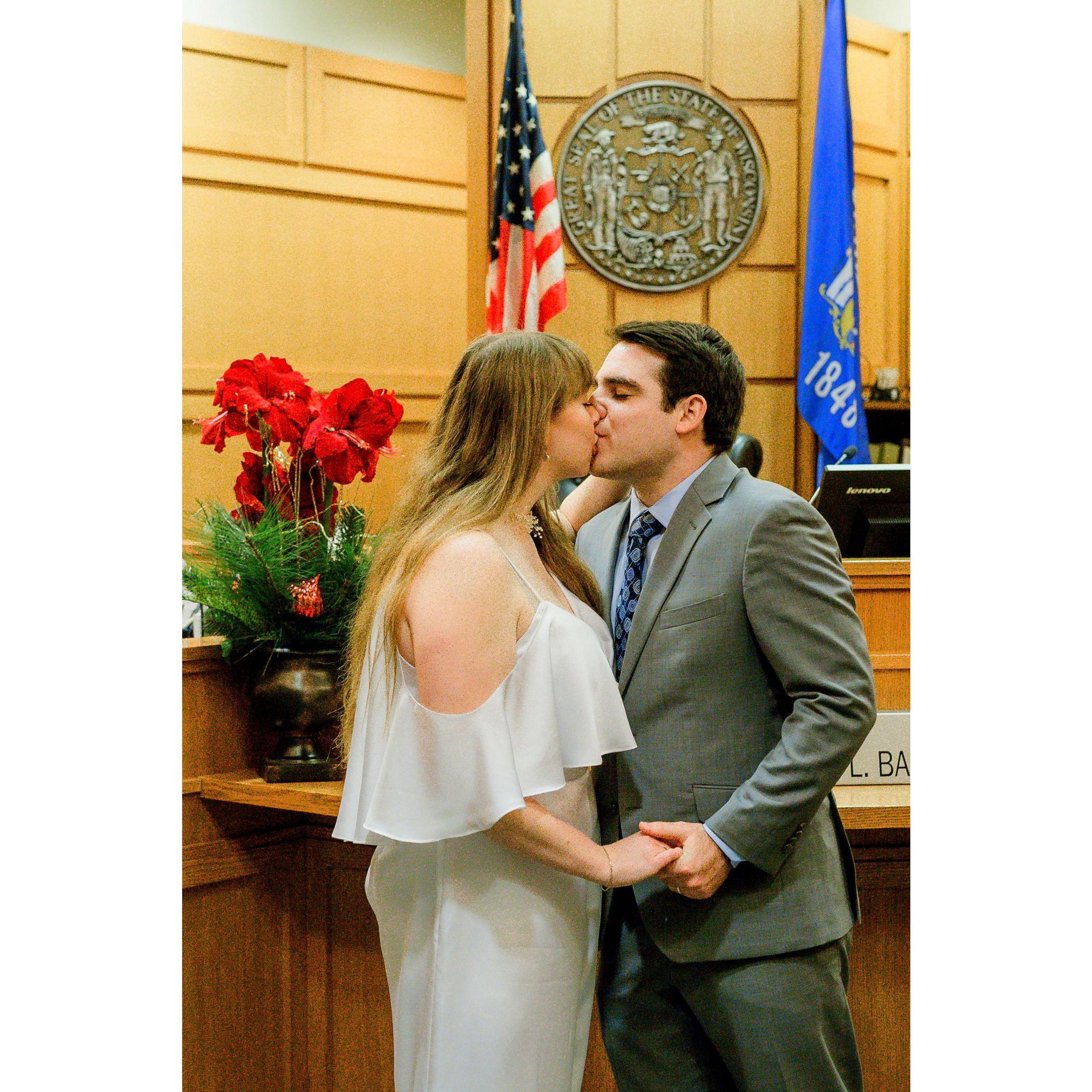 Courthouse kiss prior to signing the papers.
