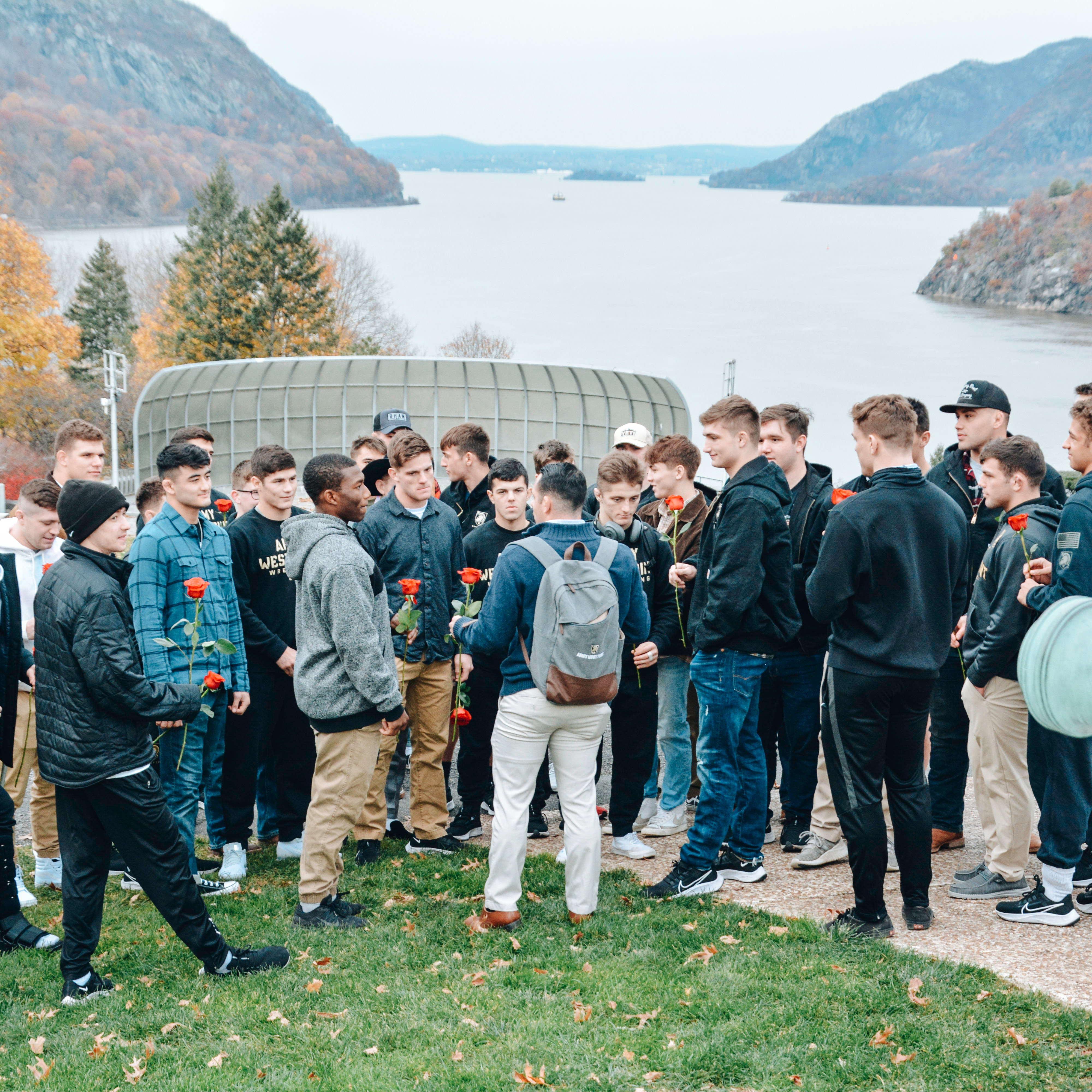 Joe preparing the West Point wrestling team to surprise Kat for the big proposal!