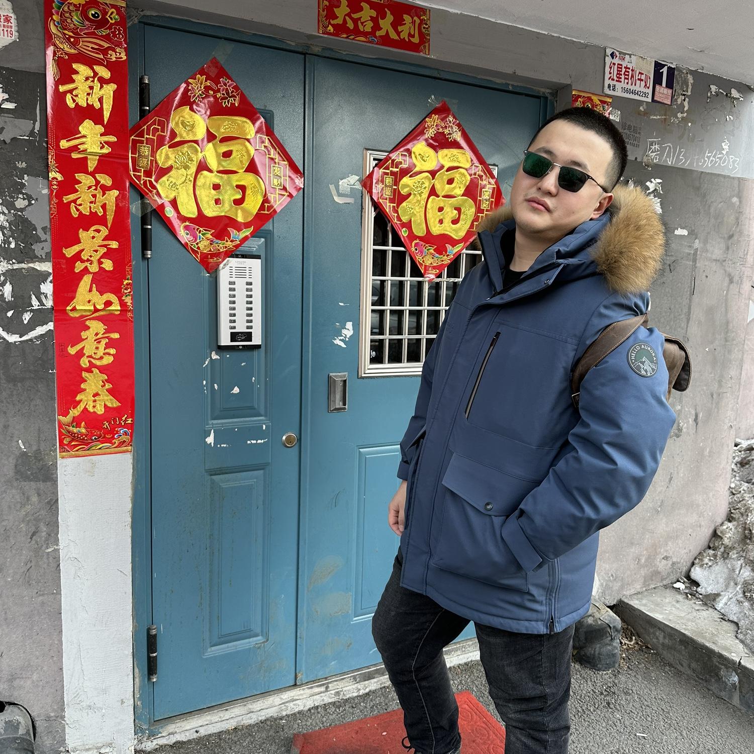 Haonan in front of his parents’ apartment building in Qitaihe - it was decorated for Lunar New Year 2024. In this photo, he is very proud of his new transition sunglasses (Allison made fun of them).