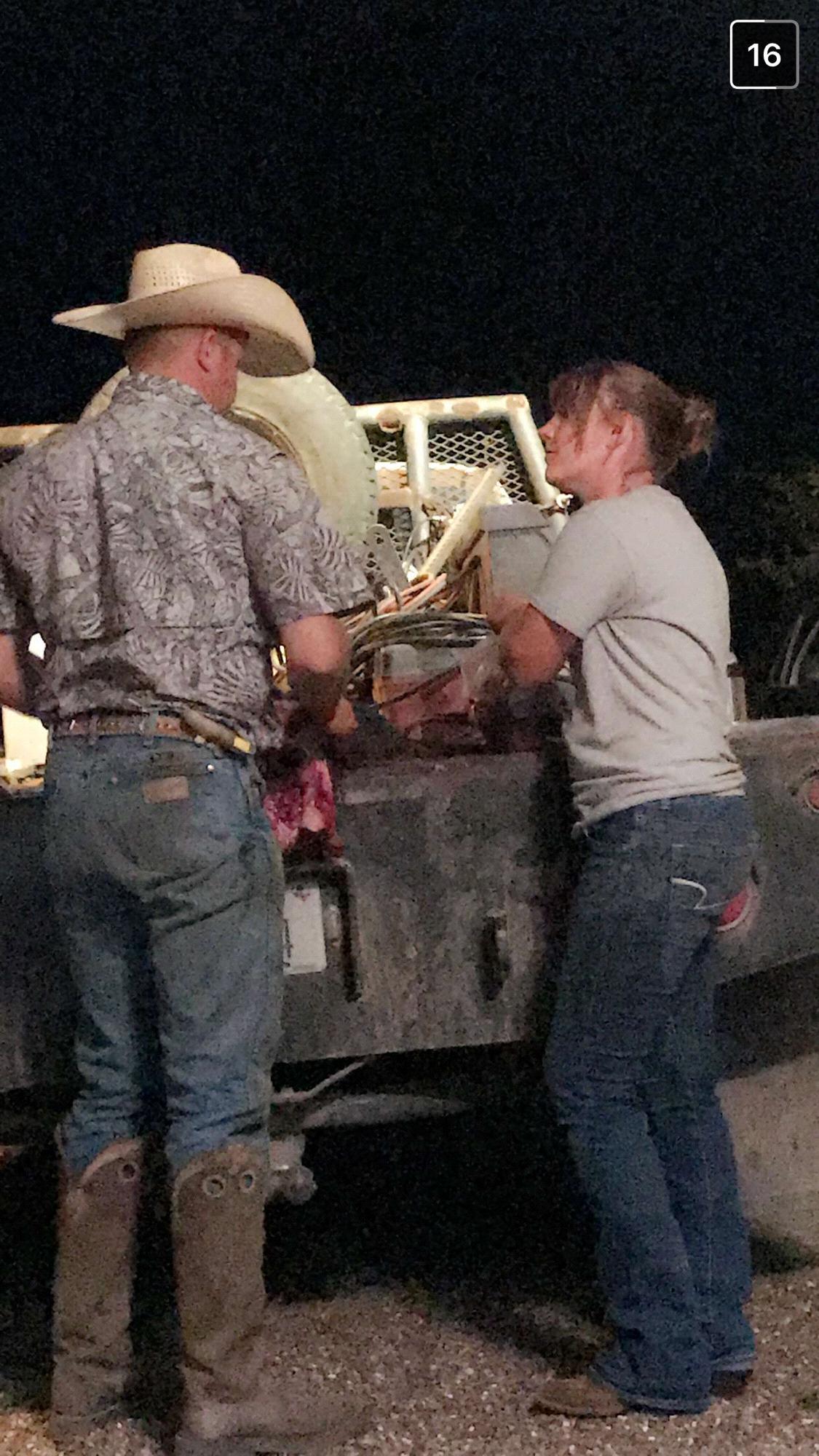 Tj and Brittany cleaning a hog