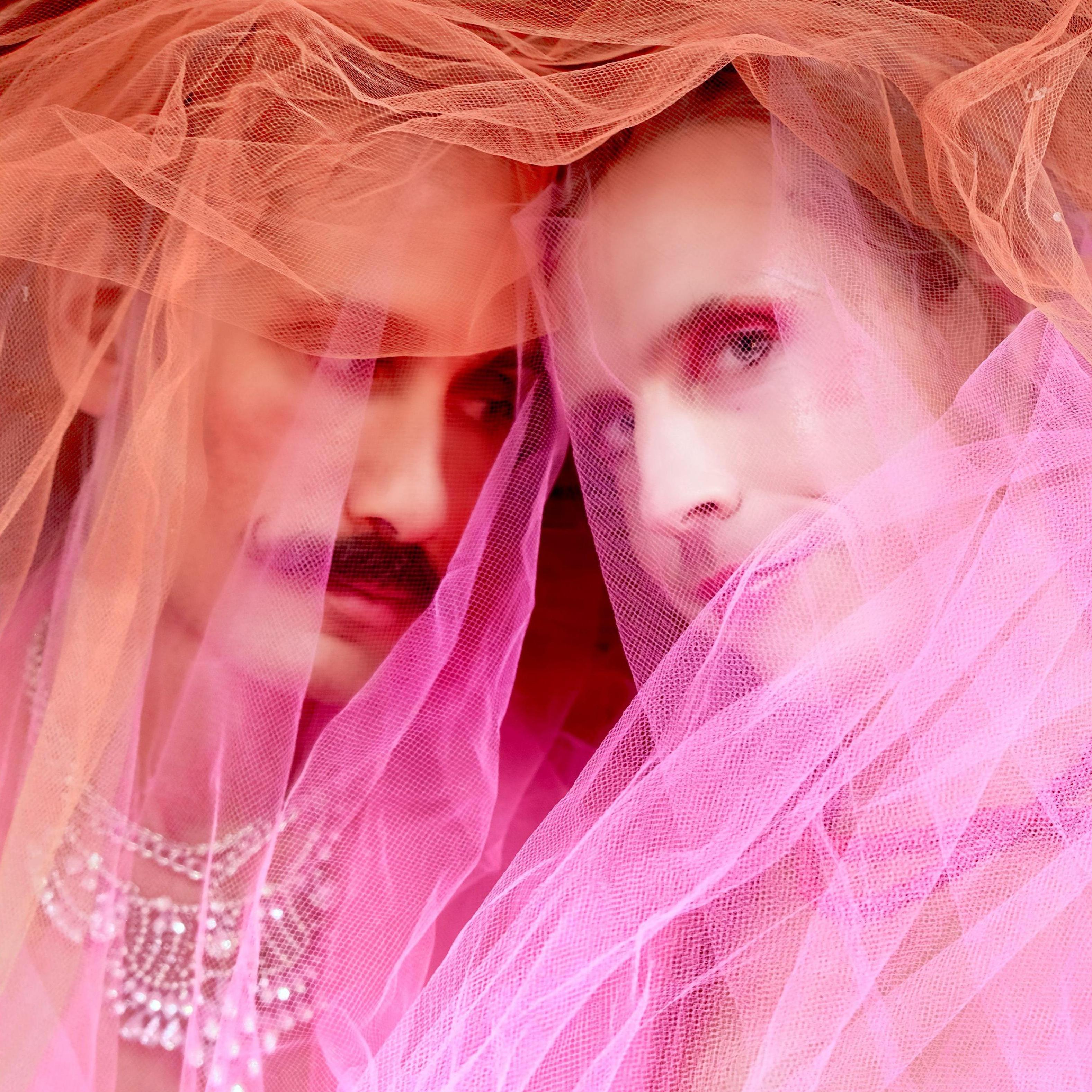 Lane and John-Paul play dress up and pose for @queeringbeauty. We're wrapped in pink and red tulle