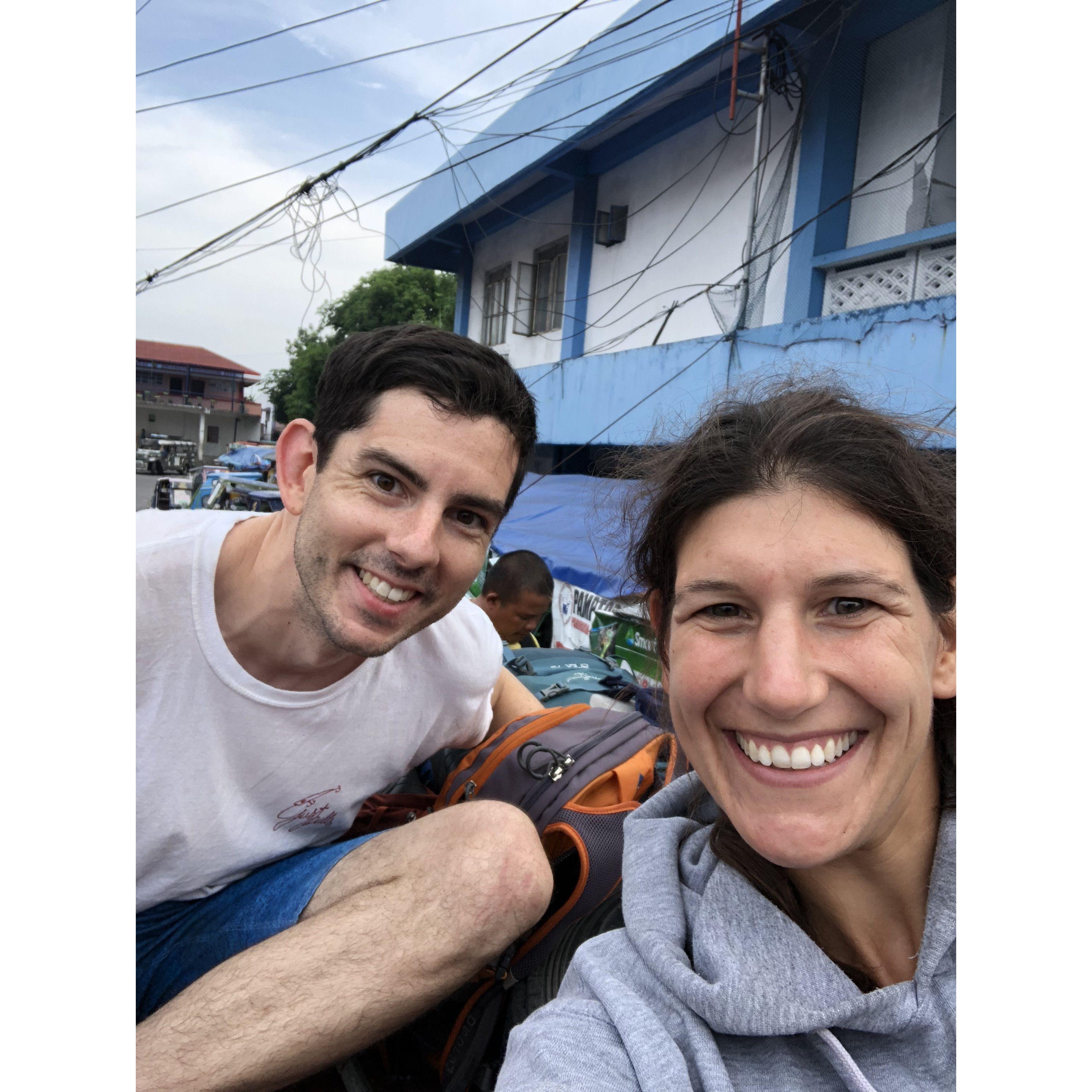 Riding on top of the roof of a bus in the Philippines