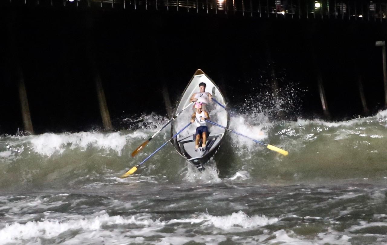 Trevor (at the top) rowing the San Clemente Dory at the legendary lifeguard competition: Taplin Relay in Hermosa Beach.