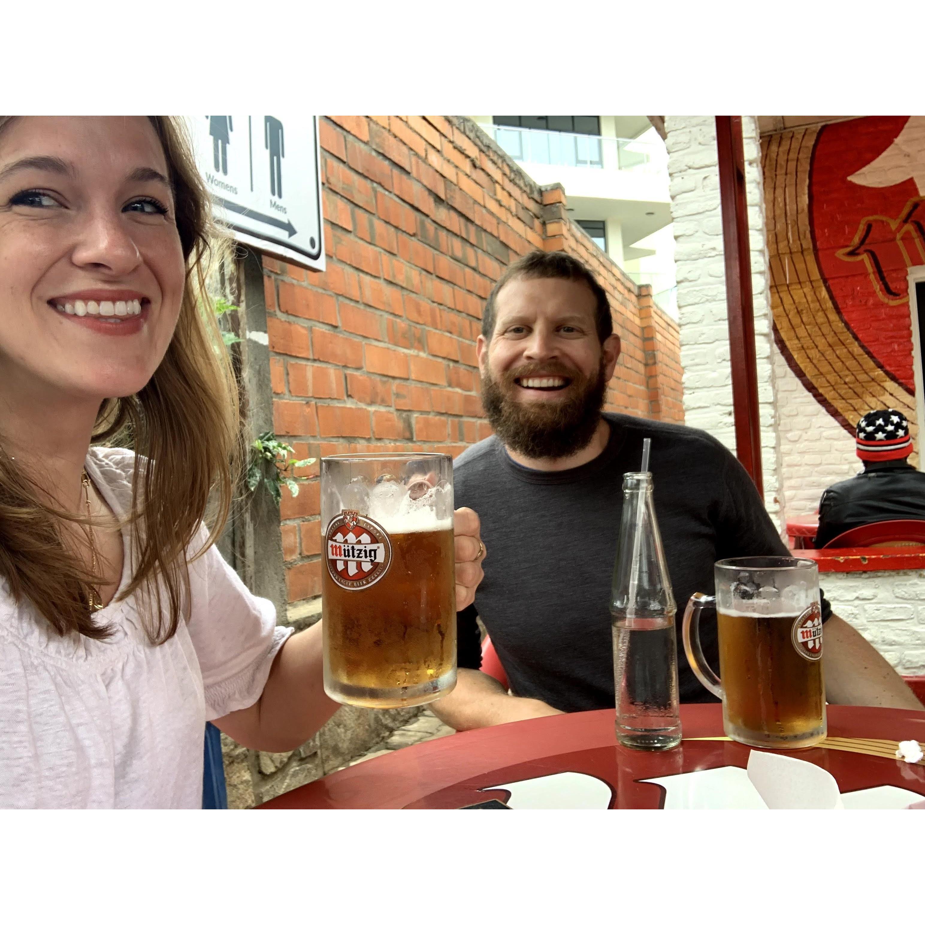 Introducing Billy to local Kigali delicacies, ie Mr. Chips and Mutzig. October 2020.