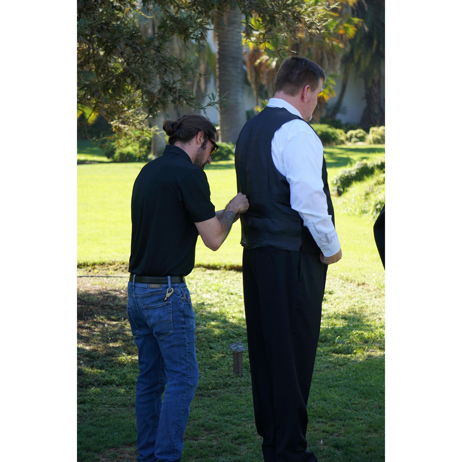 Kelly being a super supportive nephew and fixing Dan's vest strap.