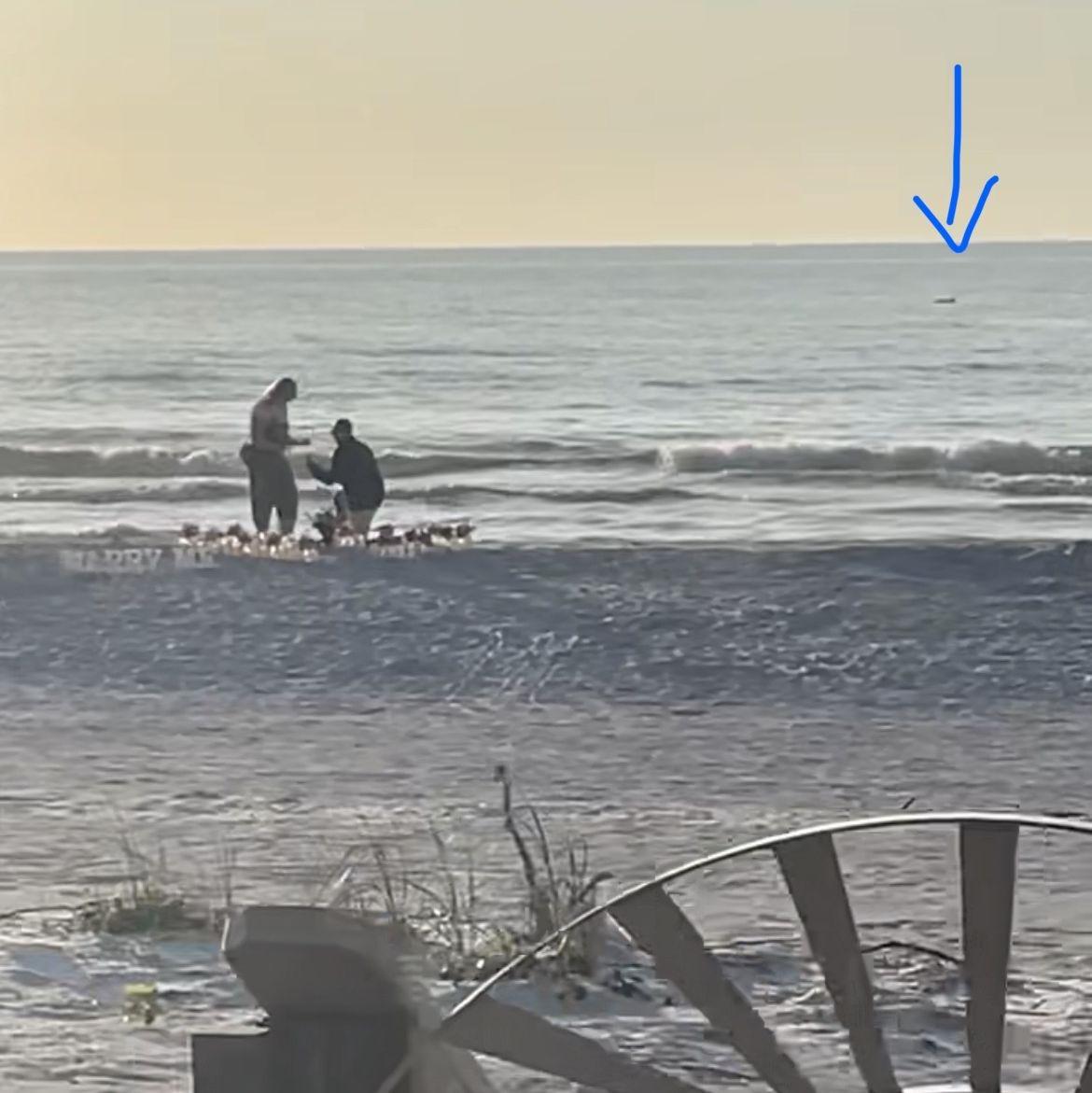This is a screenshot from the proposal video and the arrow is pointing to a dolphin that appeared when Maalik was on one knee!