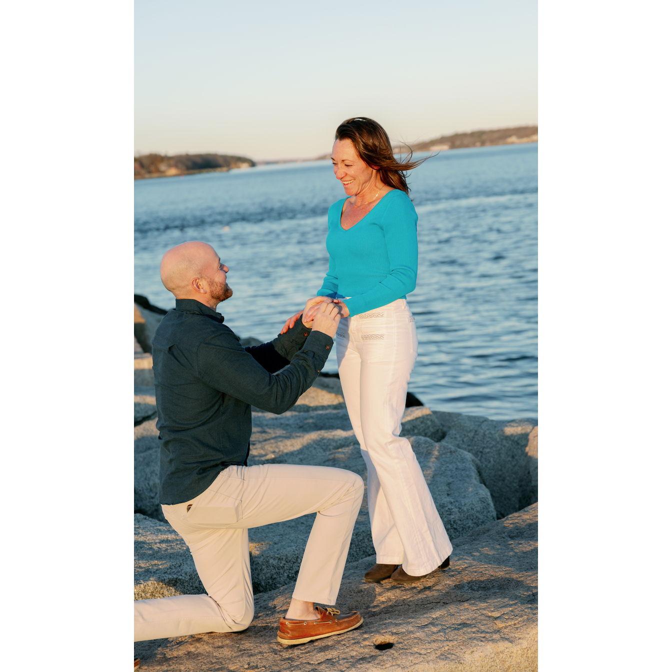 This photo was staged, but Pete DID propose on his boat, the Kristine J, just off of Long Island with Cape Elizabeth in the distance.