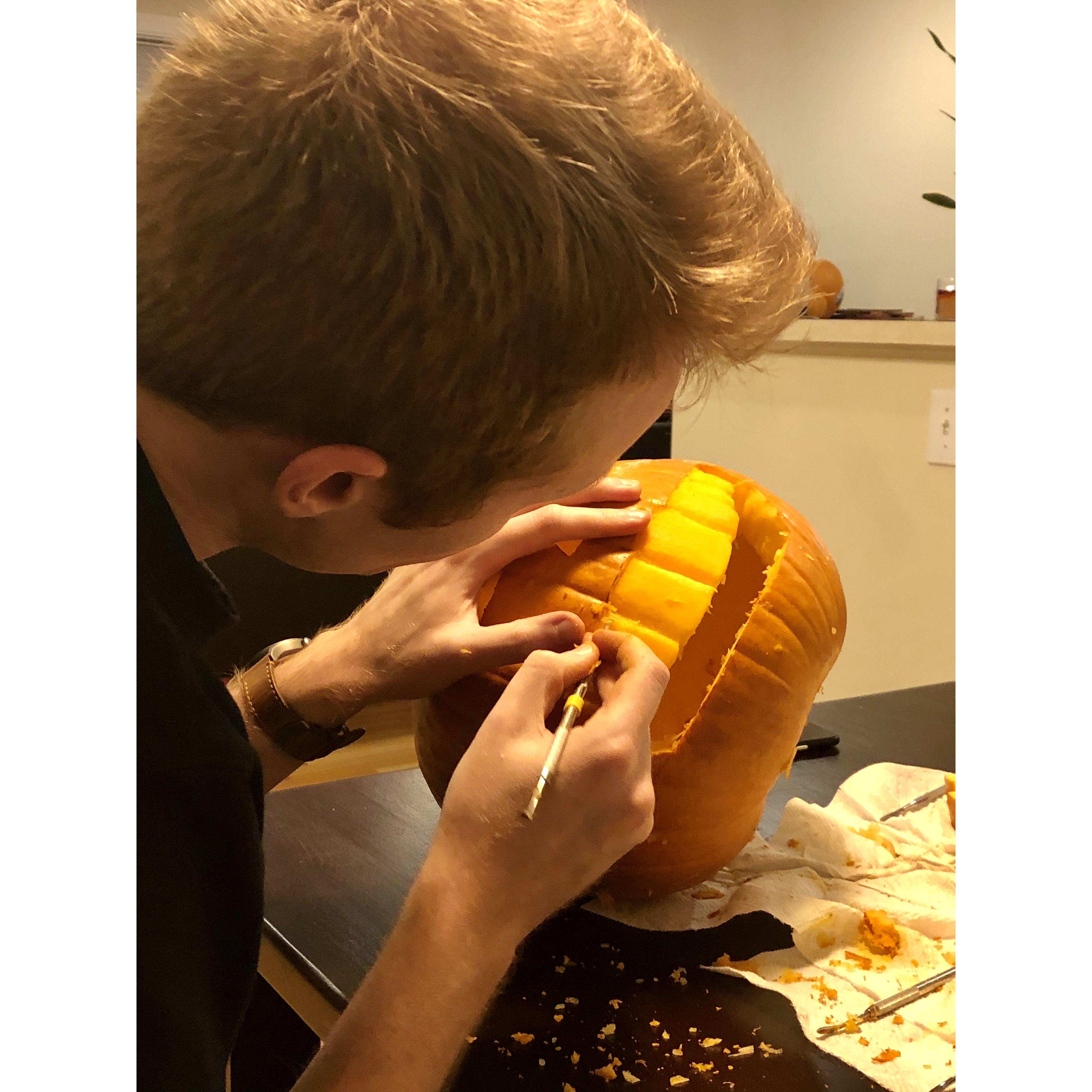 Carving our first pumpkins together... look at those perfect teeth! - October 2020