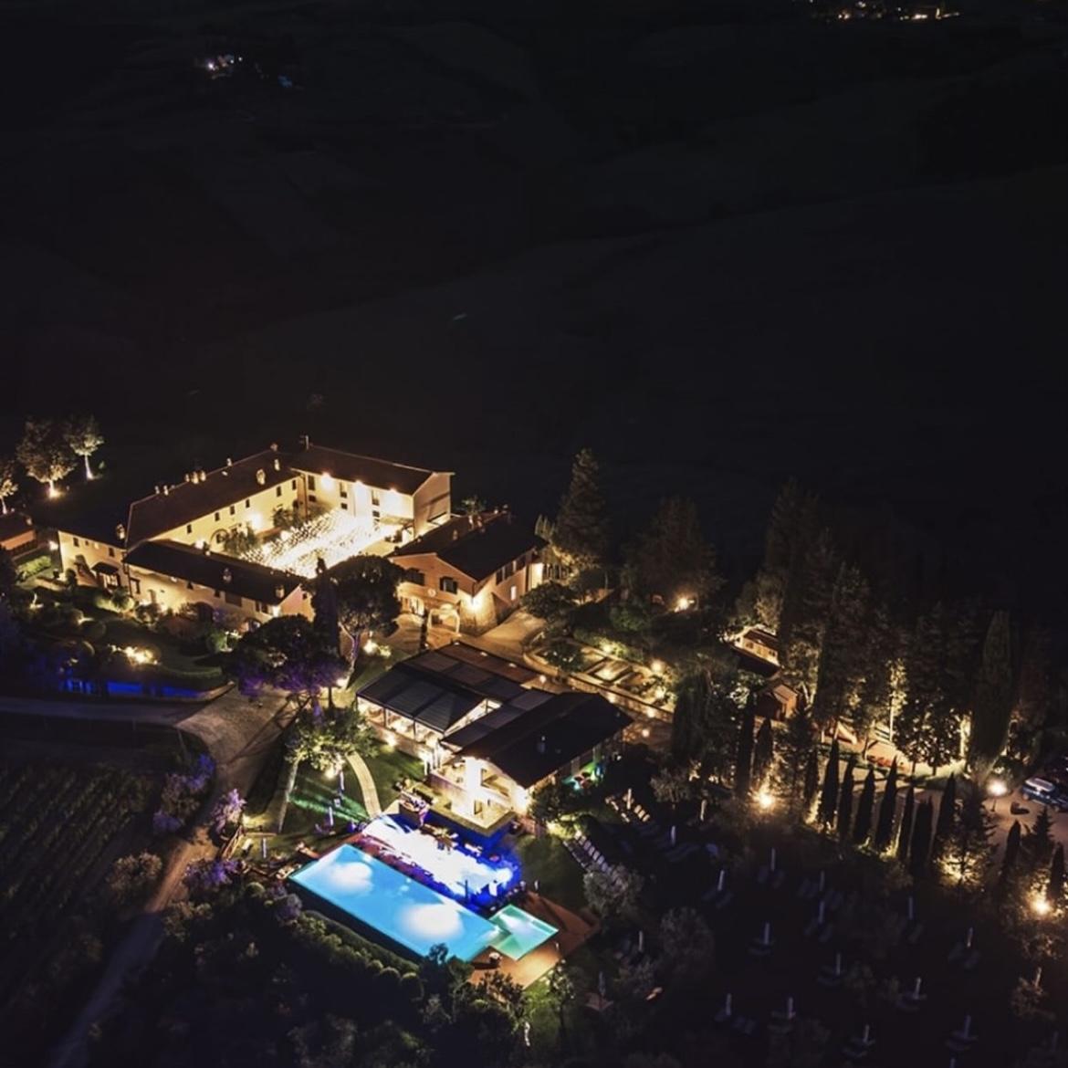 As the sun sets, our venue transforms into a glowing haven under the Tuscan sky.