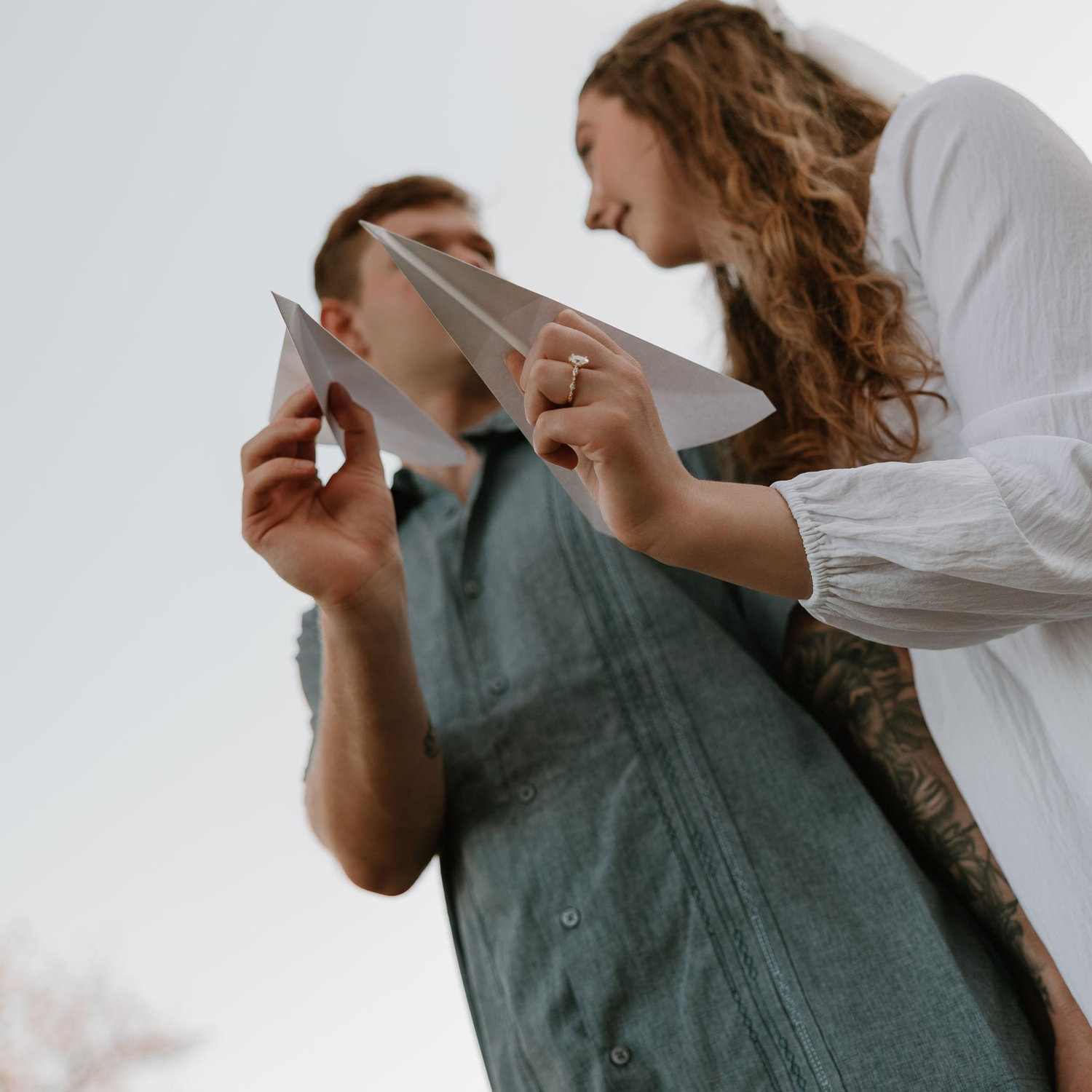 From having met on an airplane to Aaron being in the Air Force, airplanes mean a lot to us. Our brilliant photographer came up with the idea of doing a dreamy photo shoot with paper airplanes!