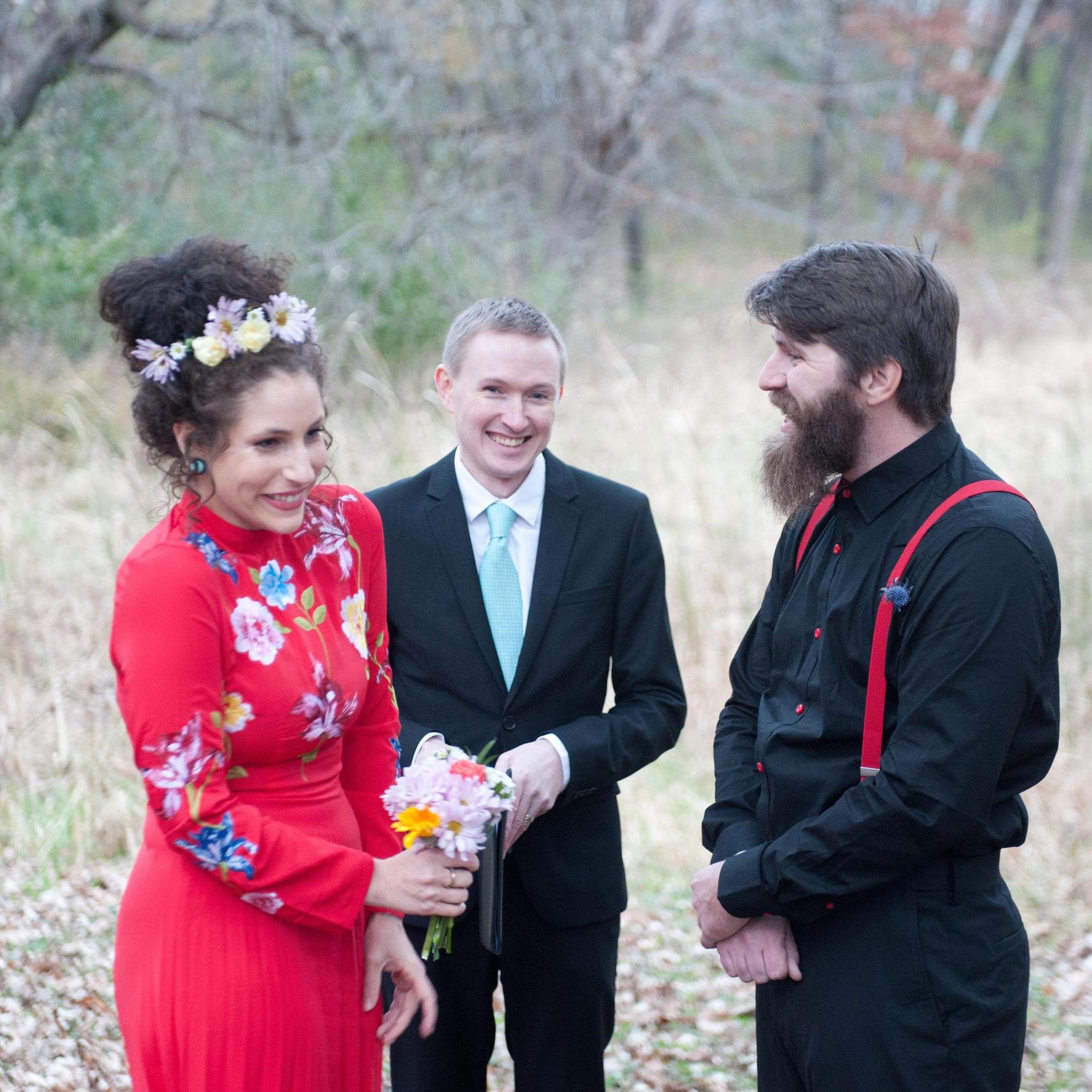 Laughing as we exchange vows during our wedding ceremony, officiated by Clint.