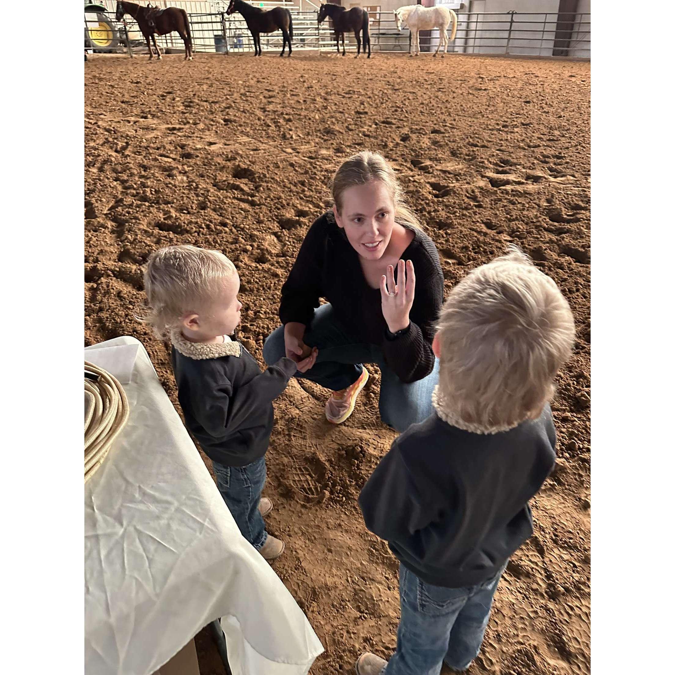 Lexie showing the most perfect ring to the boys.
